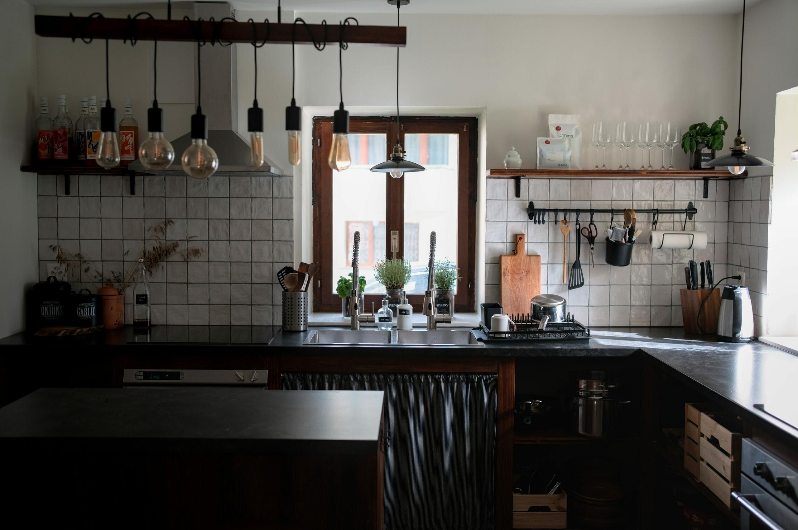 The large 20 sqm fully equipped shared kitchen at Alpiness coliving, with cooking stations, island, and storage.