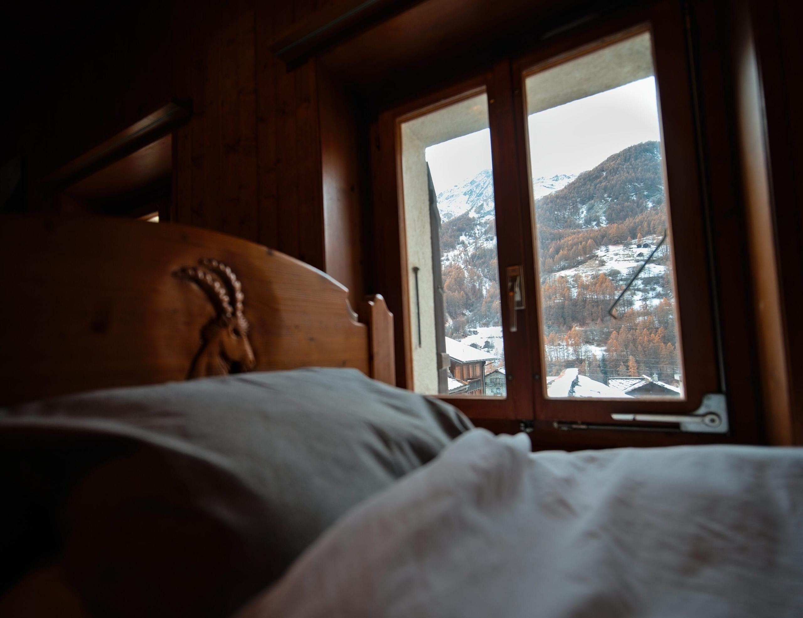 Another view of the shared room at Alpiness coliving with separation curtains for privacy.