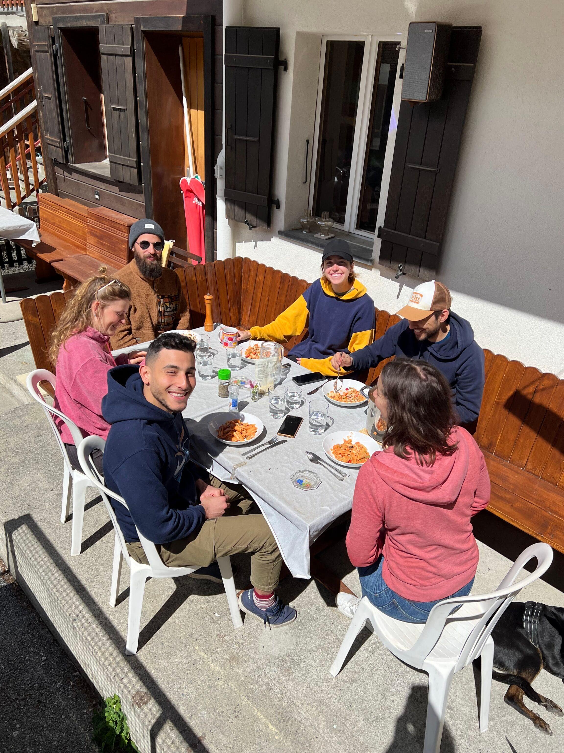 Colivers enjoying the terrace at Alpiness coliving with mountain views.