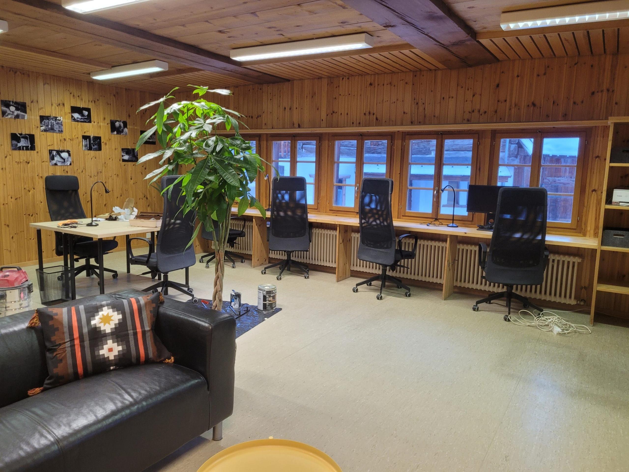 Interior of the Trava public coworking space with working stations and standing desks.