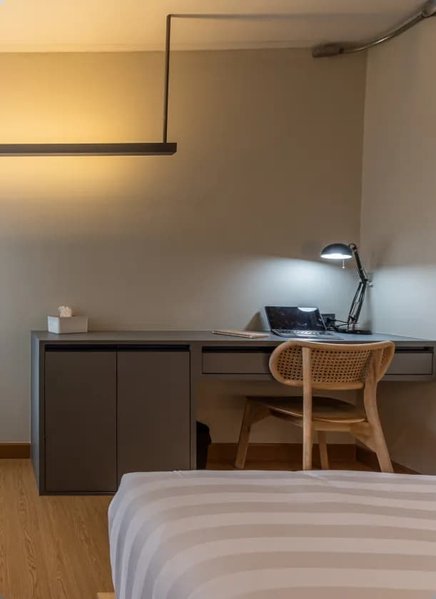 Ensuite room desk with lamp and chair, warm lighting