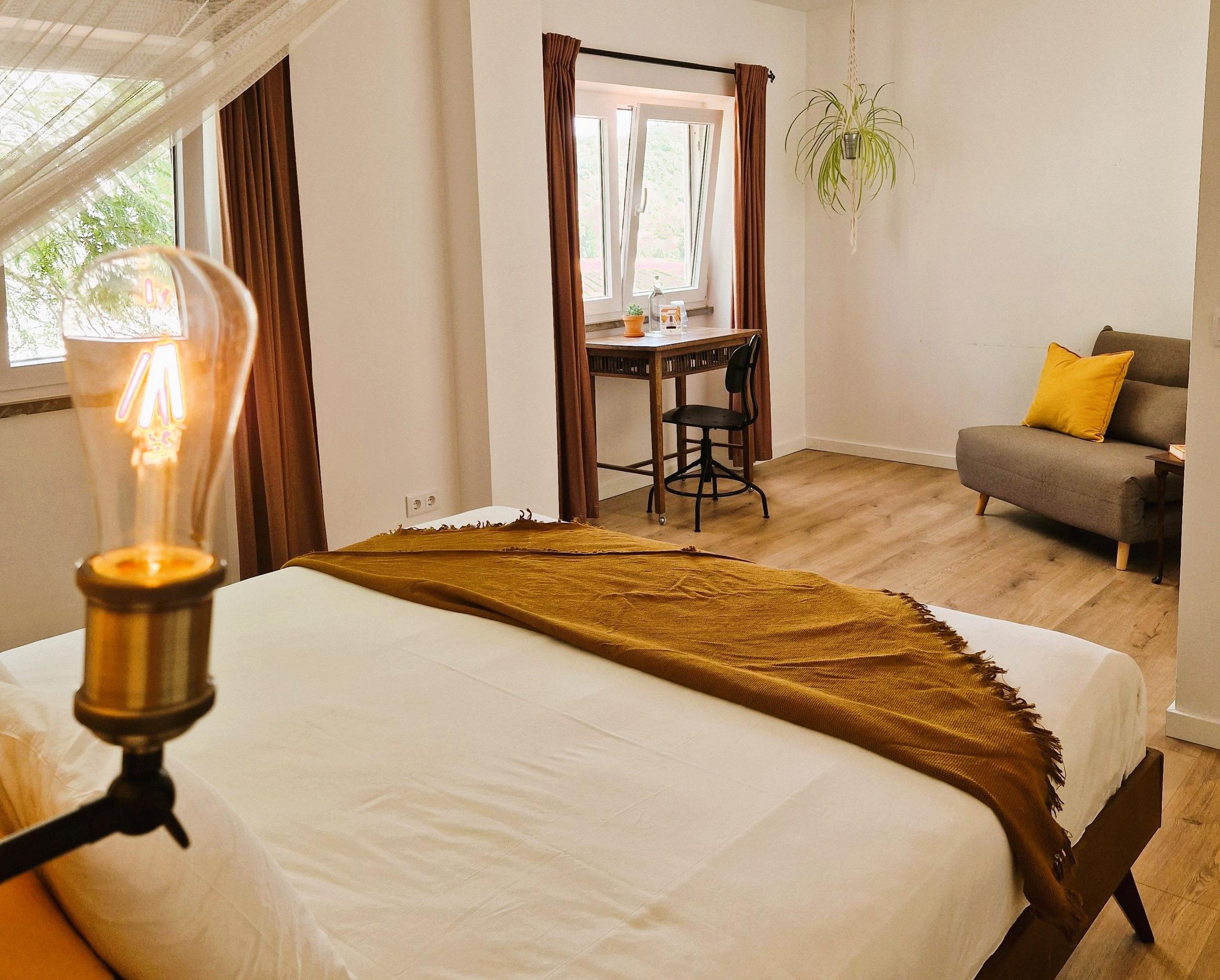 The Spacious Valley room showing kingsize bed, desk, private bathroom and sofa