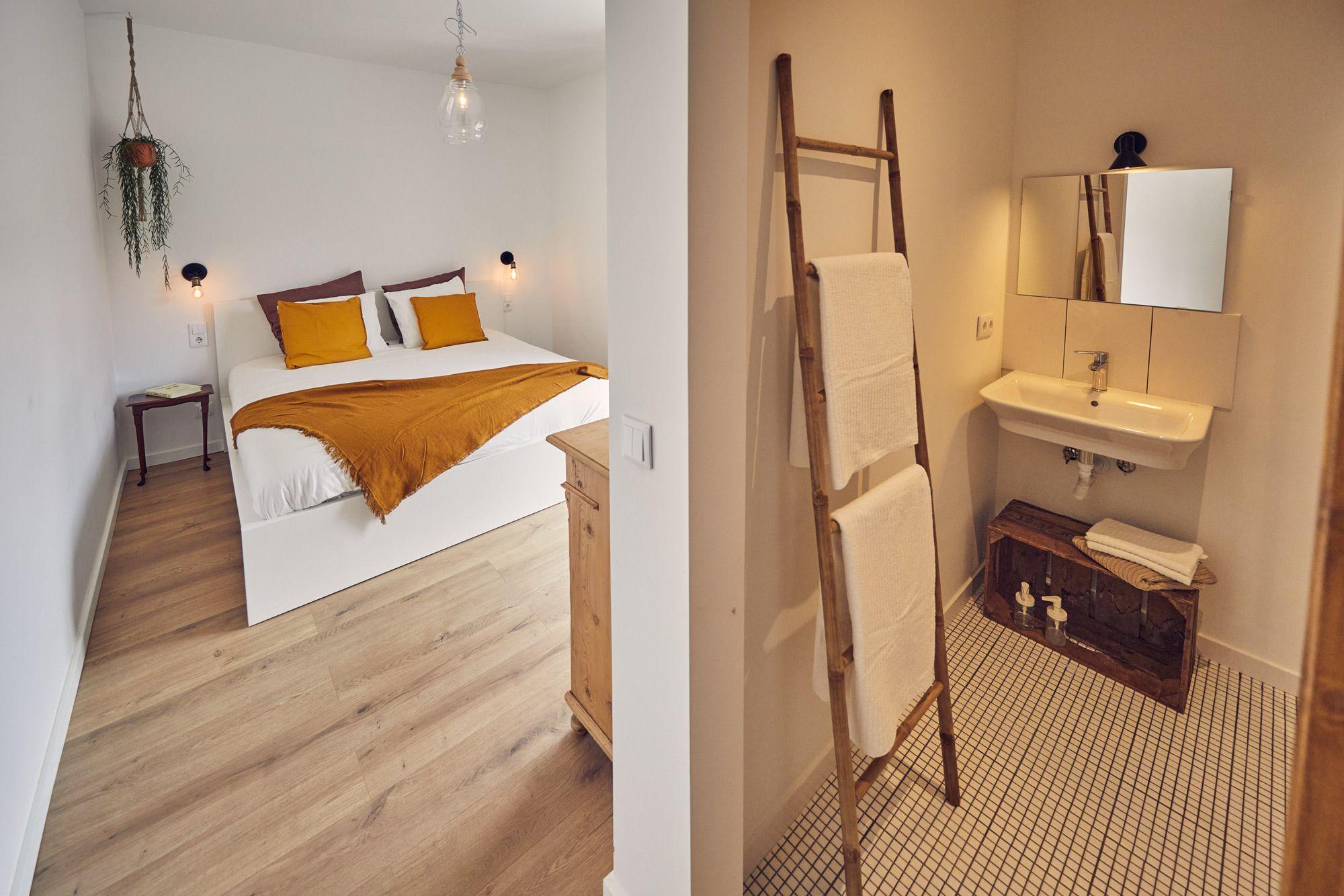 The Romantic Valley room showing the balcony, kingsize bed and bathroom