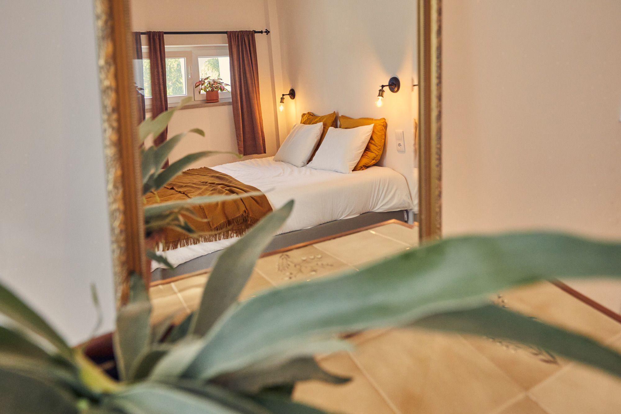 The Snug Pine room with bed and mirror