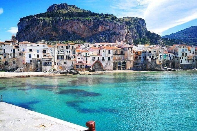 Panoramic view of Cefalù, a coastal town in Sicily with turquoise sea and the iconic rock