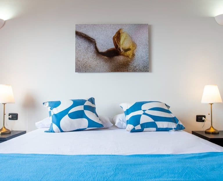 One of the rooms for remote workers with a bed and a blue blanket