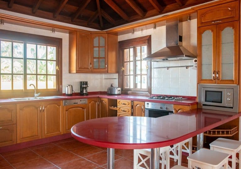 Spacious kitchen with wooden cabinets and all the amenities for remote workers in Tenerife