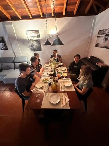 Colivers sharing a dinner together at the communal dining table