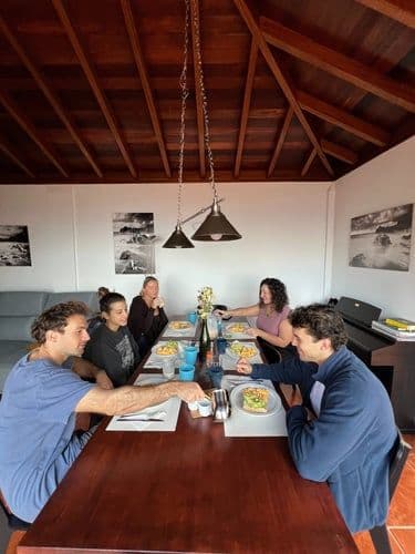 Colivers sharing a meal together at the communal dining table