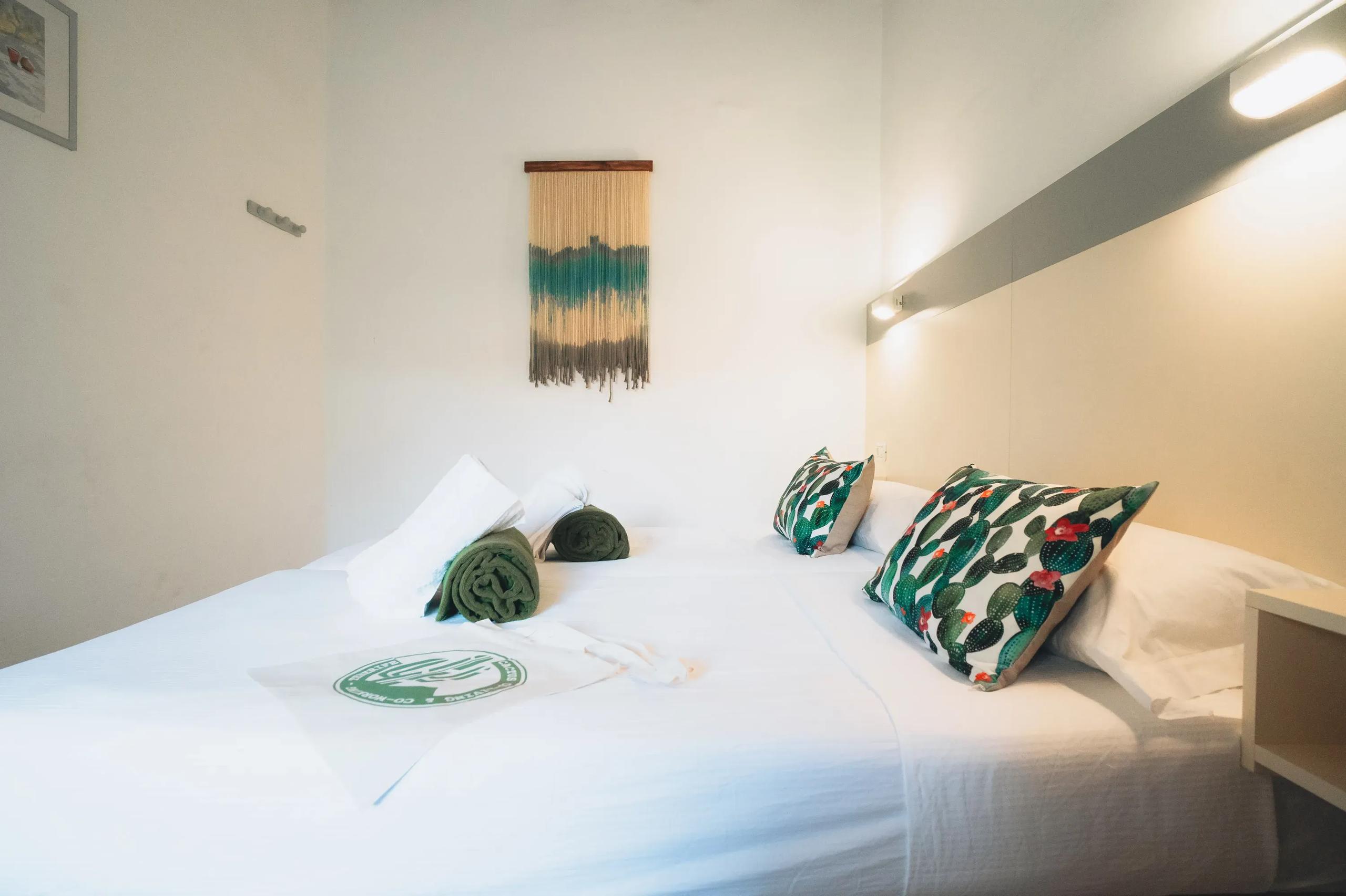 Double room with double bed and macramé wall art at Cactus La Gomera