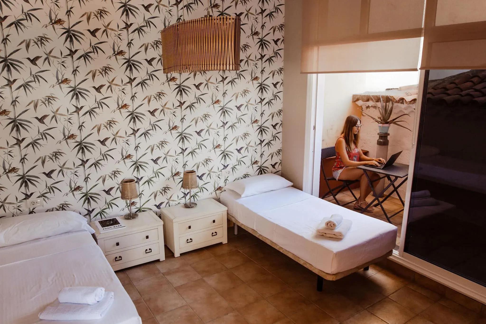 The beautifully decorated shared twin room with a terrace at Cactus Coliving Tenerife.