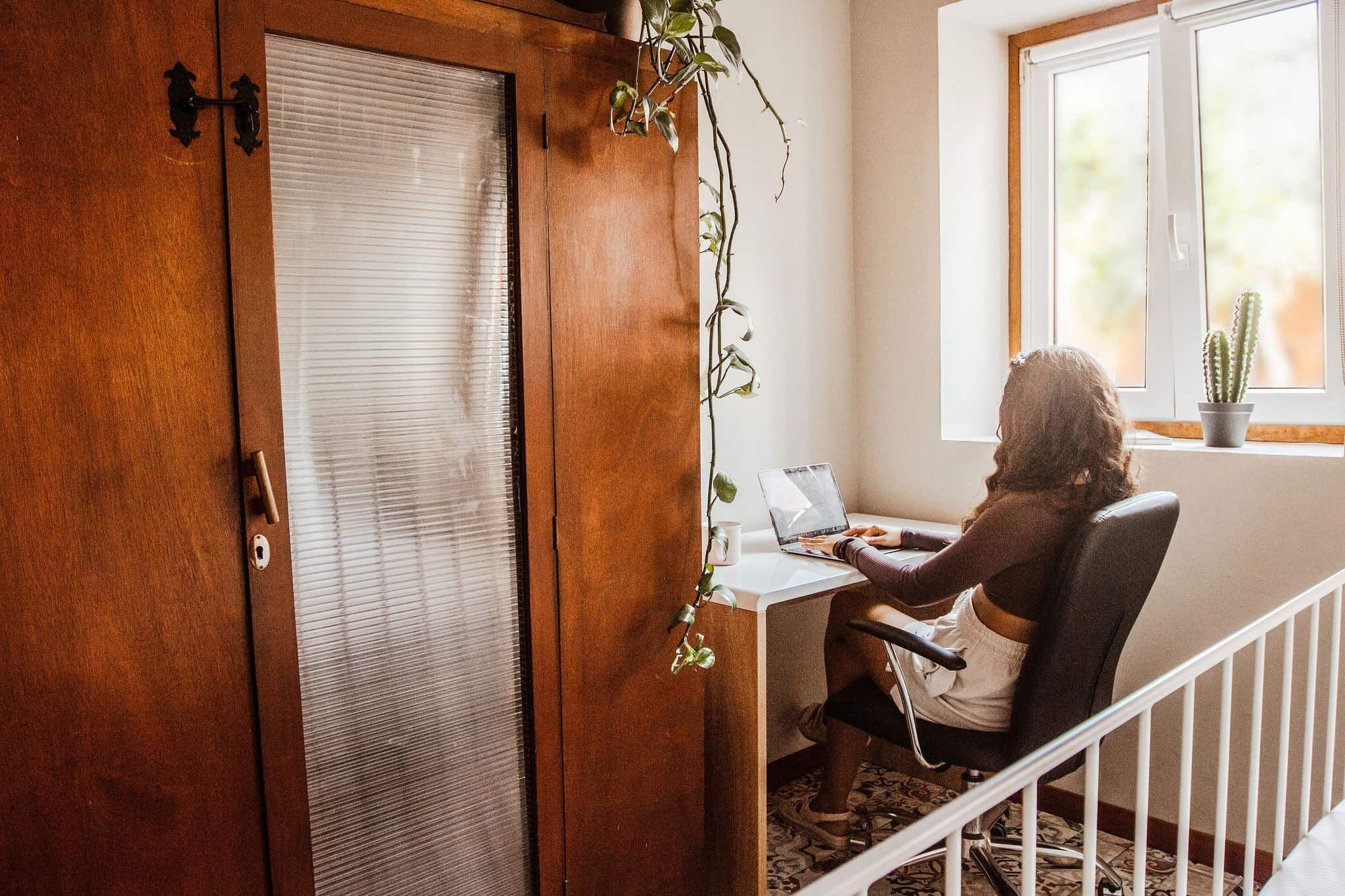 A digital Nomad comfortably working remote from their private room at Cactus Coliving Tenerife.
