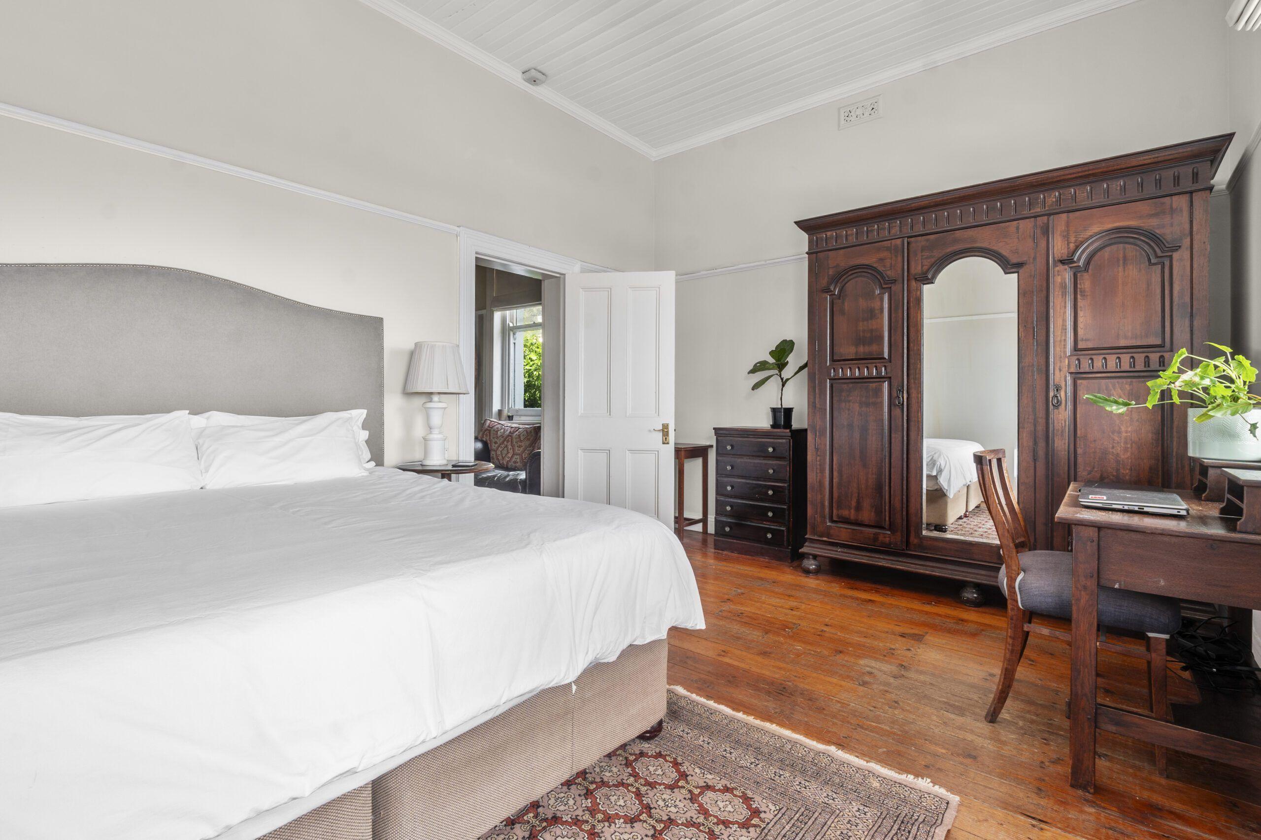 Spacious bedroom of the Master Deluxe Suite with king-sized bed