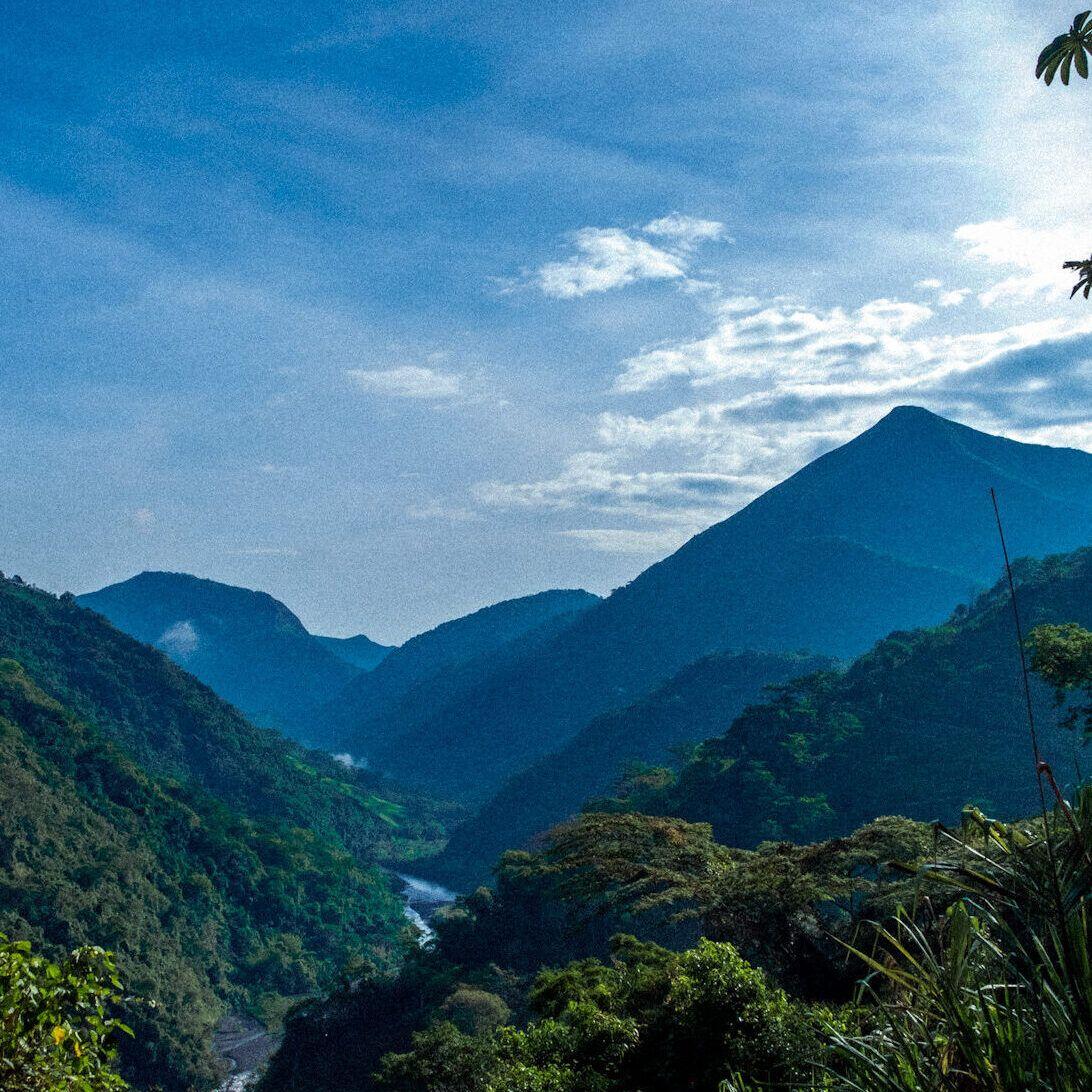 Panoramic view of lush green mountains and river valley in Tobia, Colombia, surrounding Casa Kandamy
