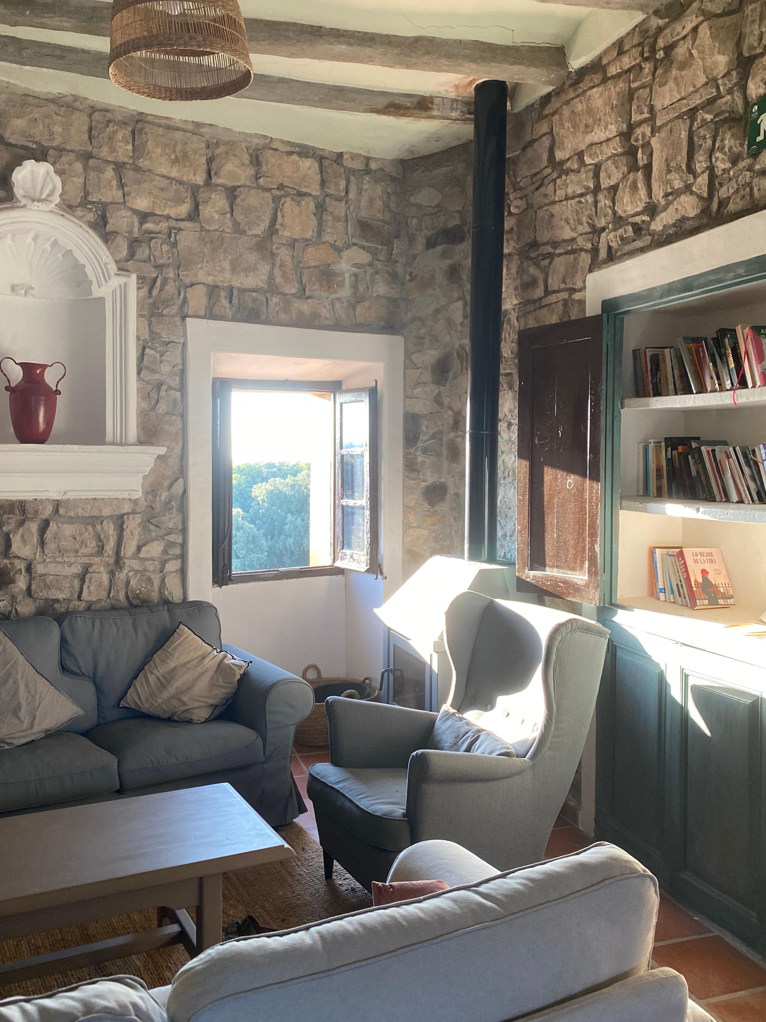 The garden and pool area at Casa Pardal with stone walls and fruit trees