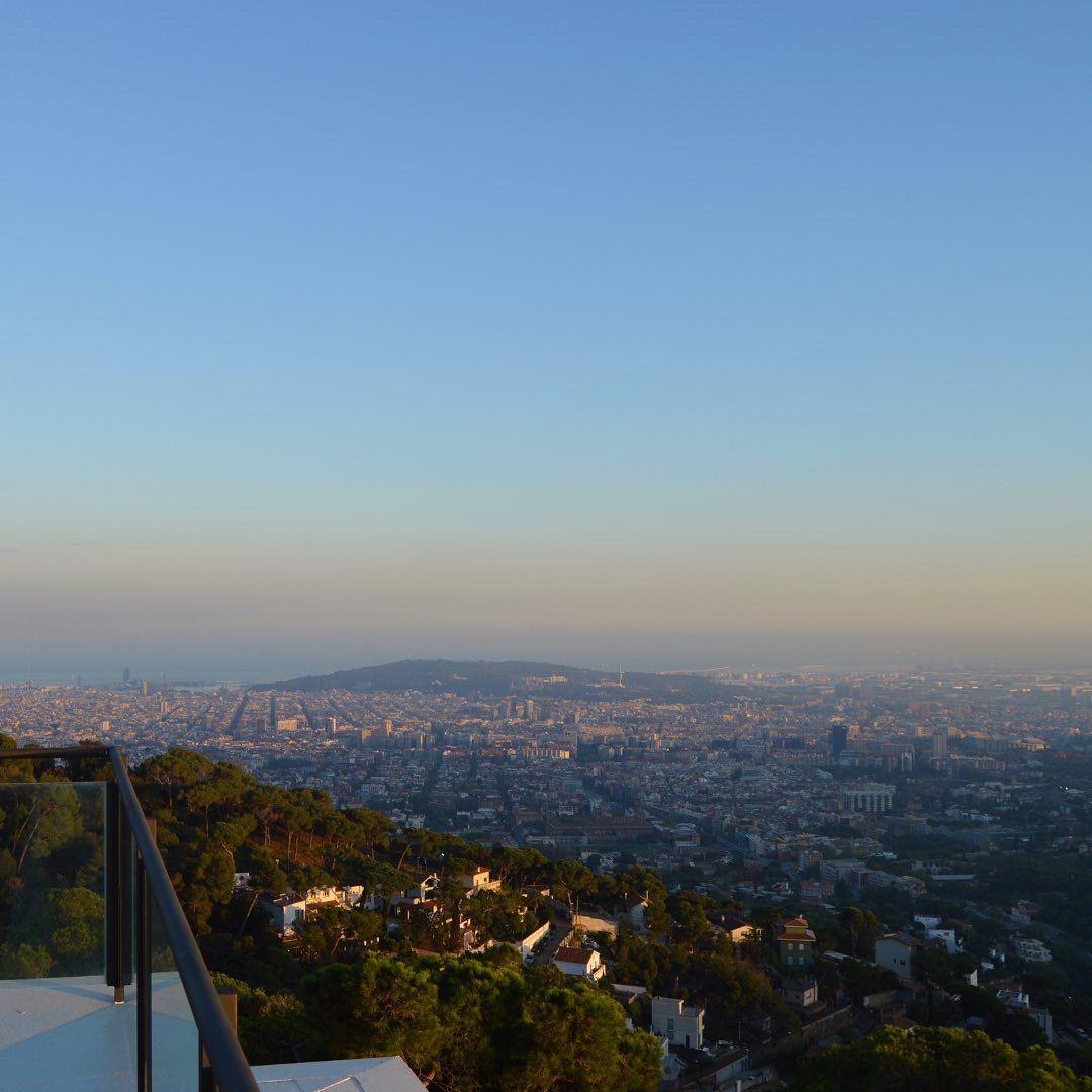 Panoramic view of Barcelona city and the sea at dusk, seen from the rooftop or terrace of Circles House.