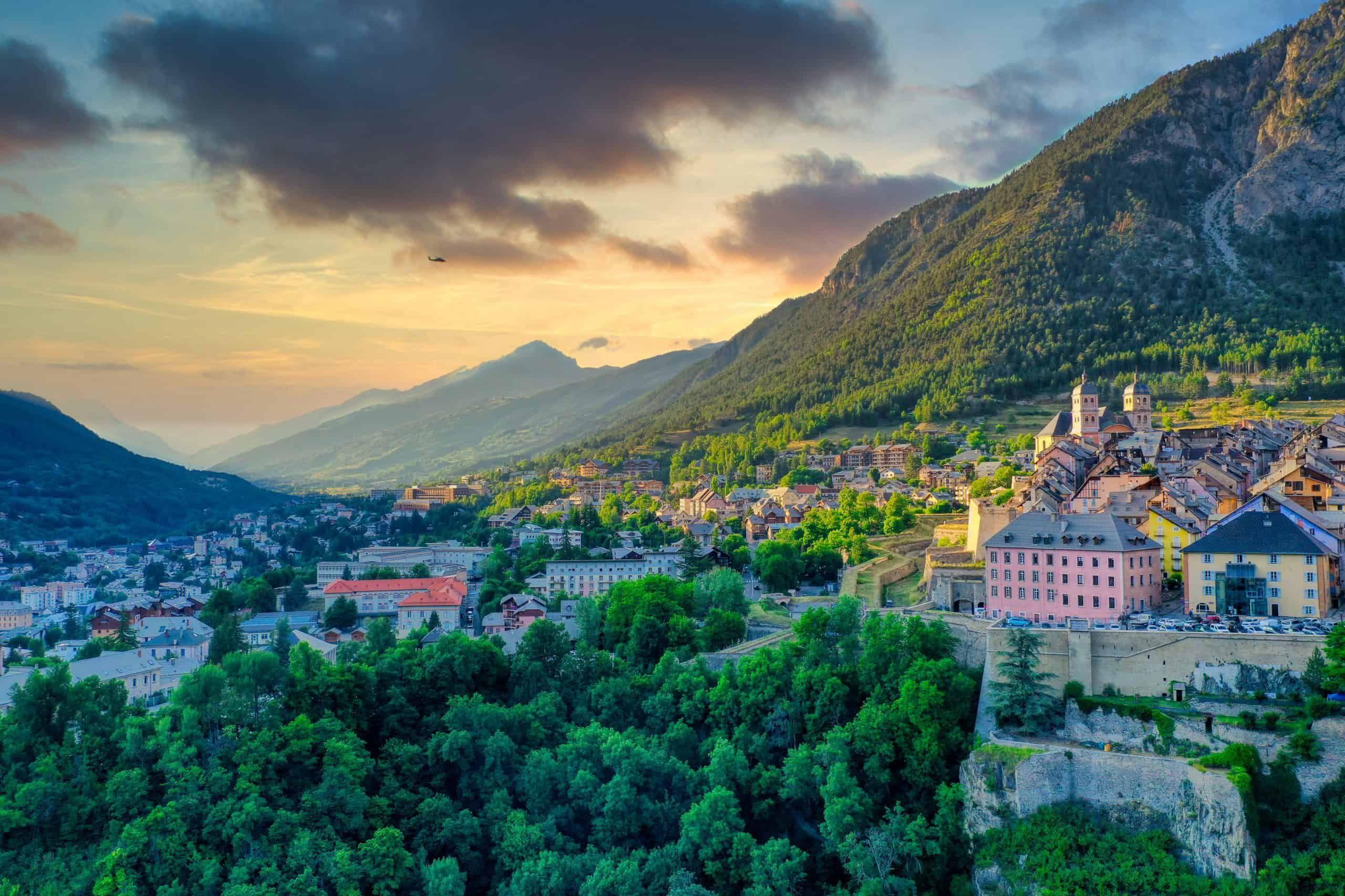 Aerial panoramic view of Briançon town with mountains and valley at sunset