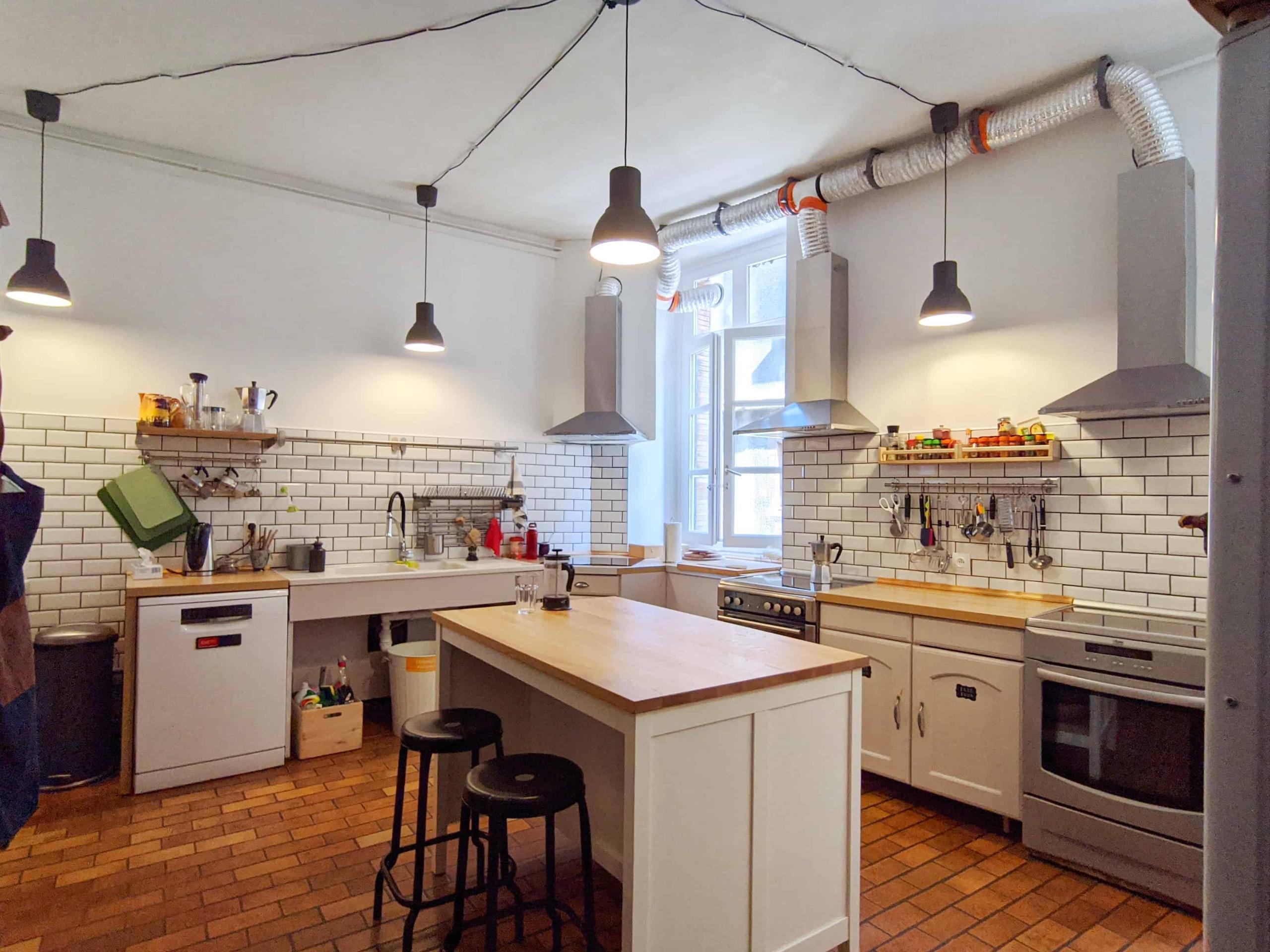 Shared kitchen with central island for cooking and socializing