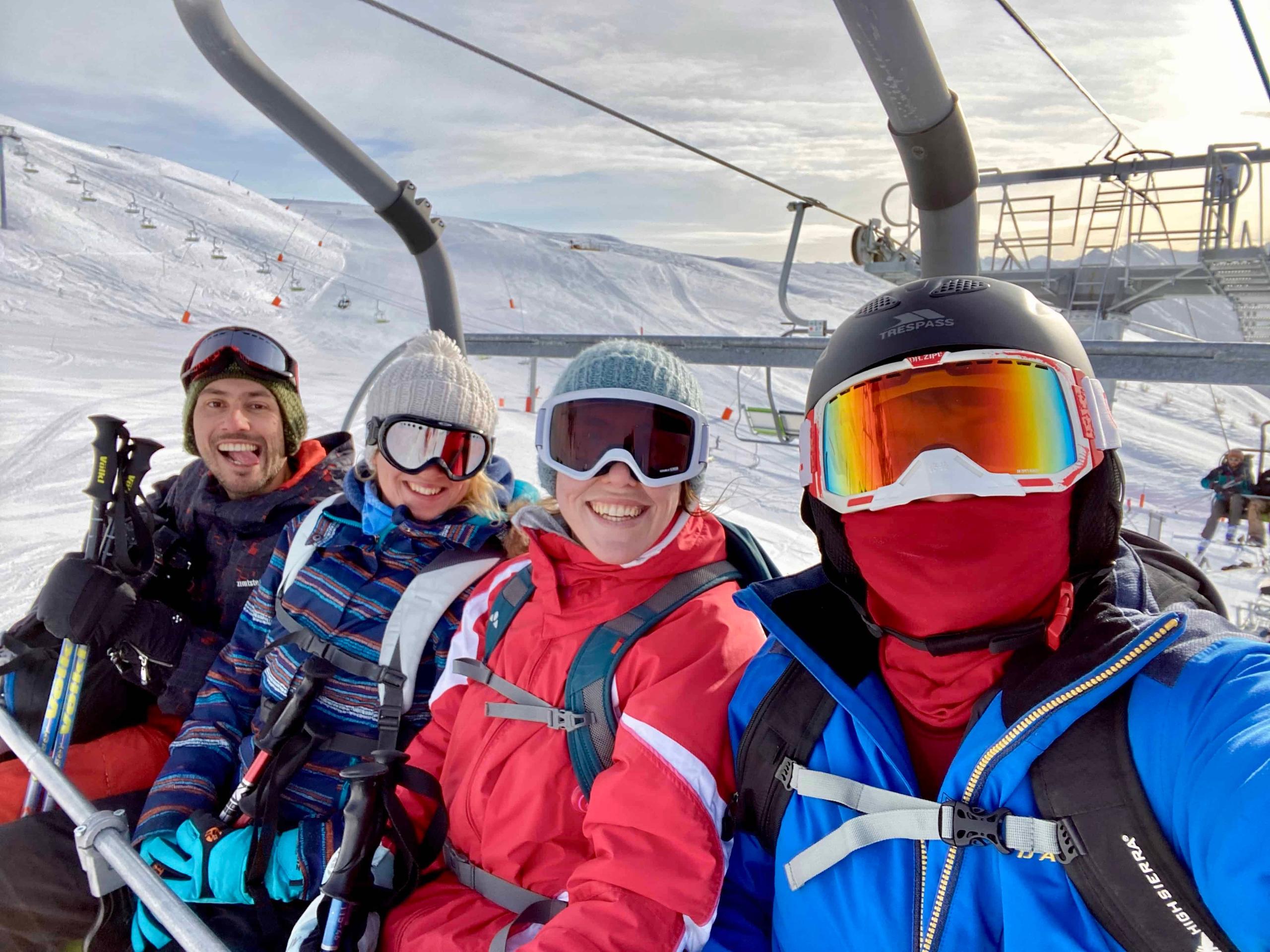 Group of four colivers on a ski lift at Serre Chevalier ski resort