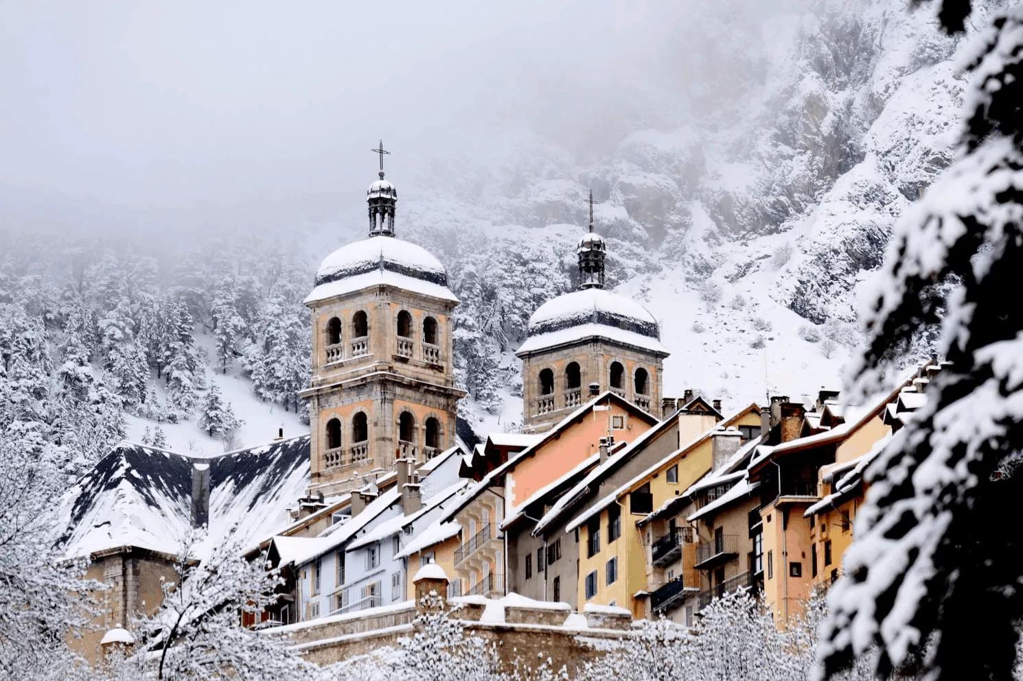 The historic old town of Briançon covered in snow with the church towers visible