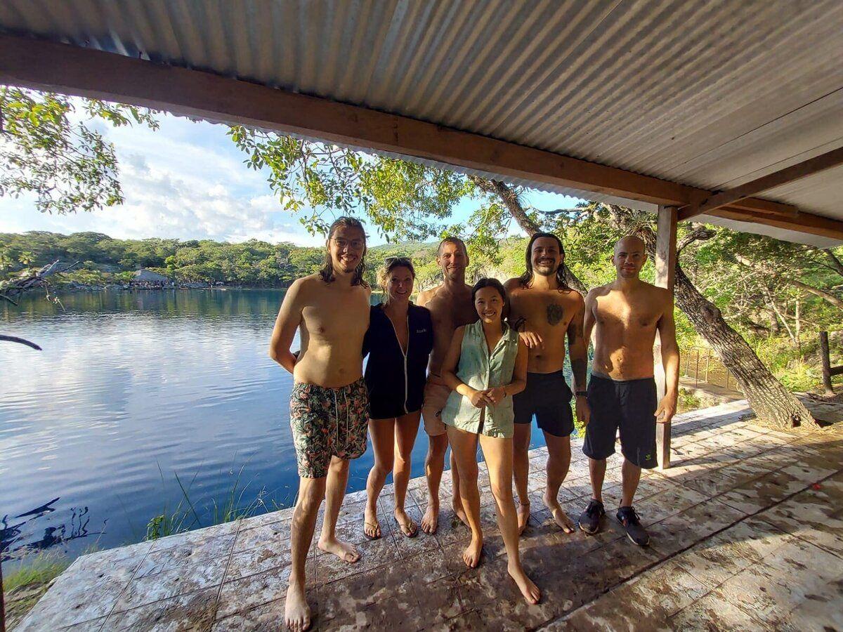 Group of Co.404 community members posing by a lake during an excursion