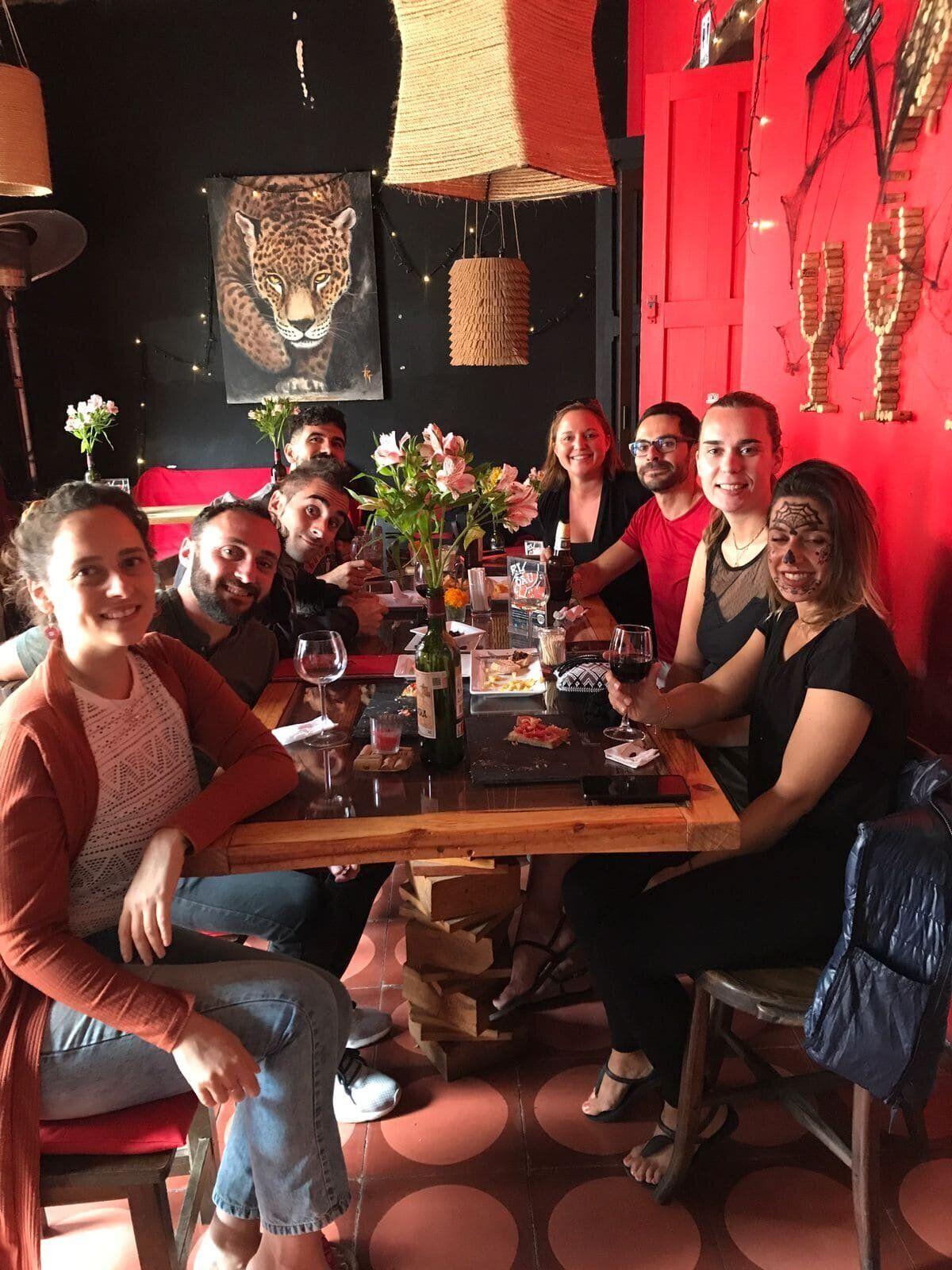Co404 community members enjoying a group dinner at a restaurant in San Cristóbal