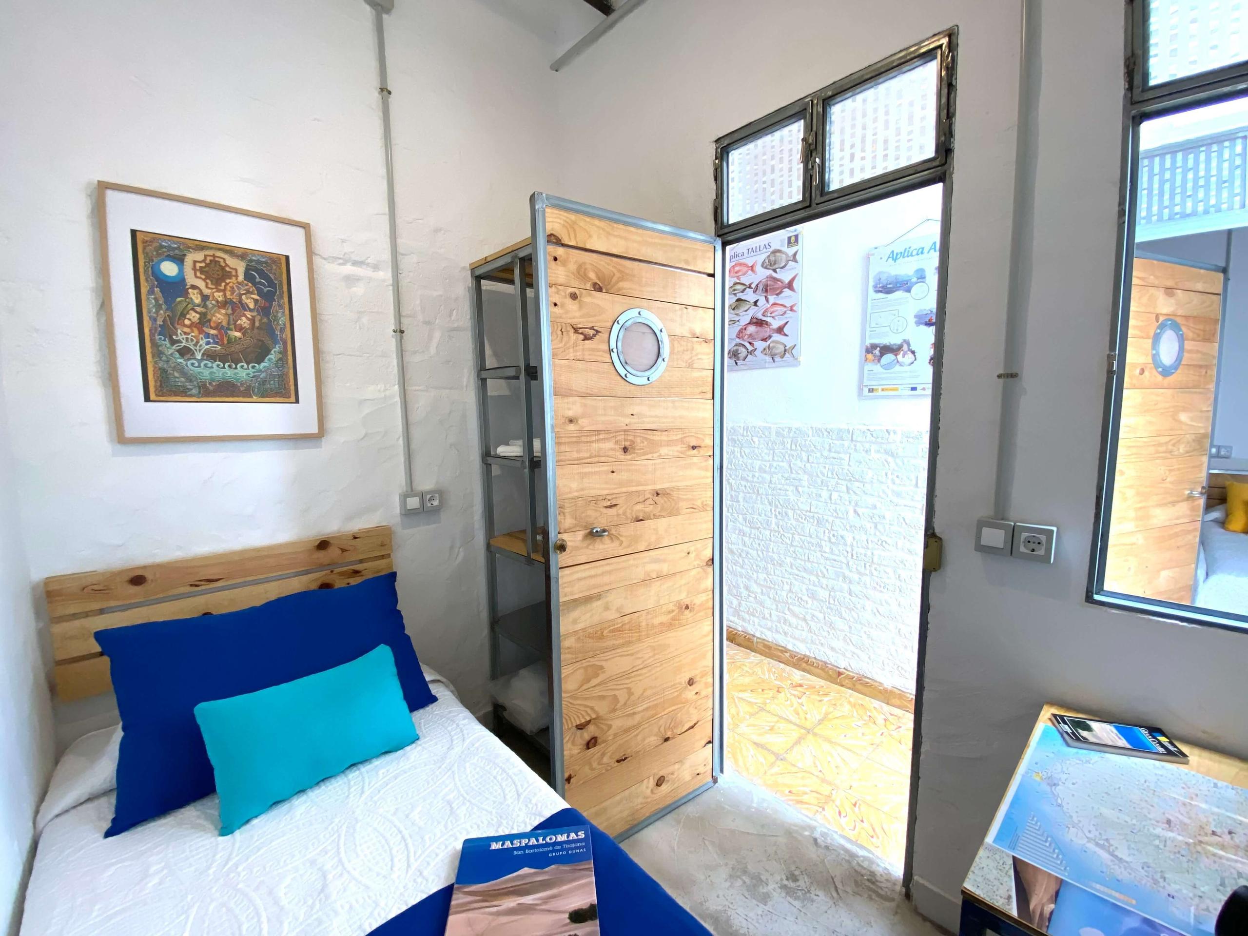 Small and economic room, with bed, wardrobe and desk inside of the room ideal for budget stays in a Coliving in Gran Canaria