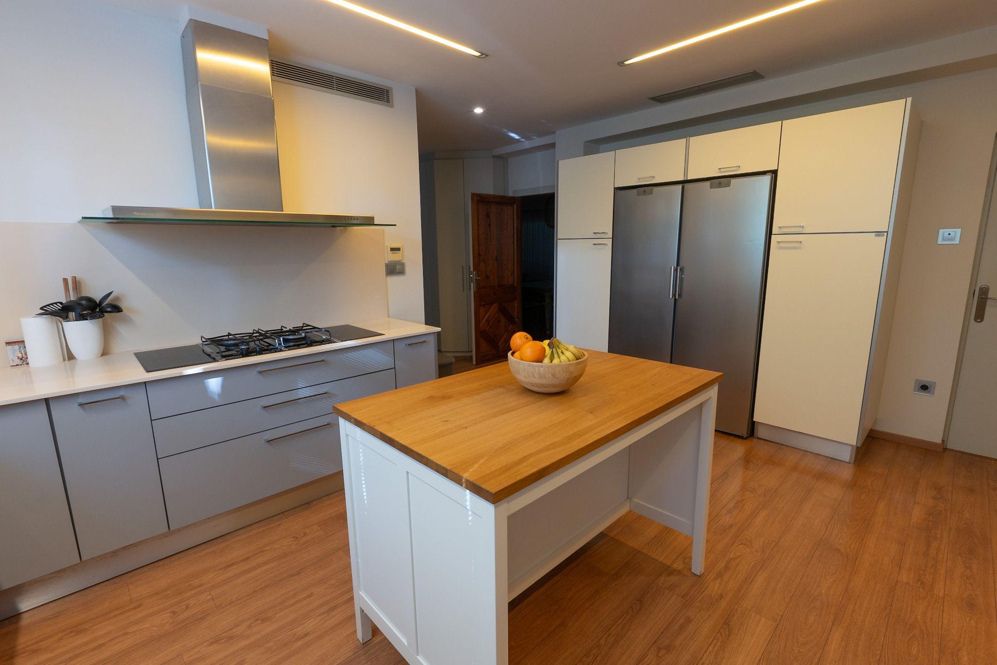 Fully equipped kitchen with double fridge, island, oven and microwave