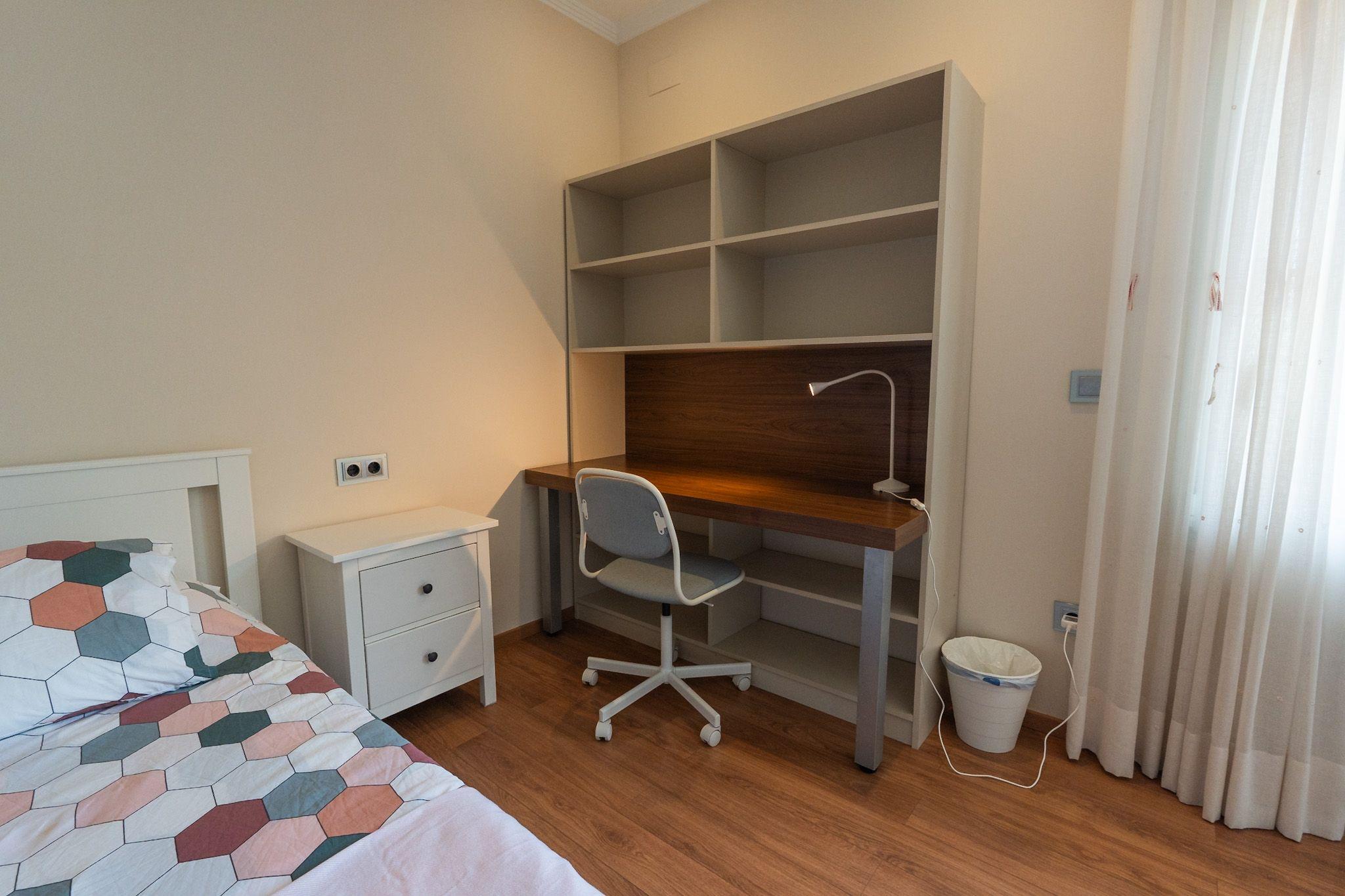 Private workspace with desk and shelving in the Oakwood room