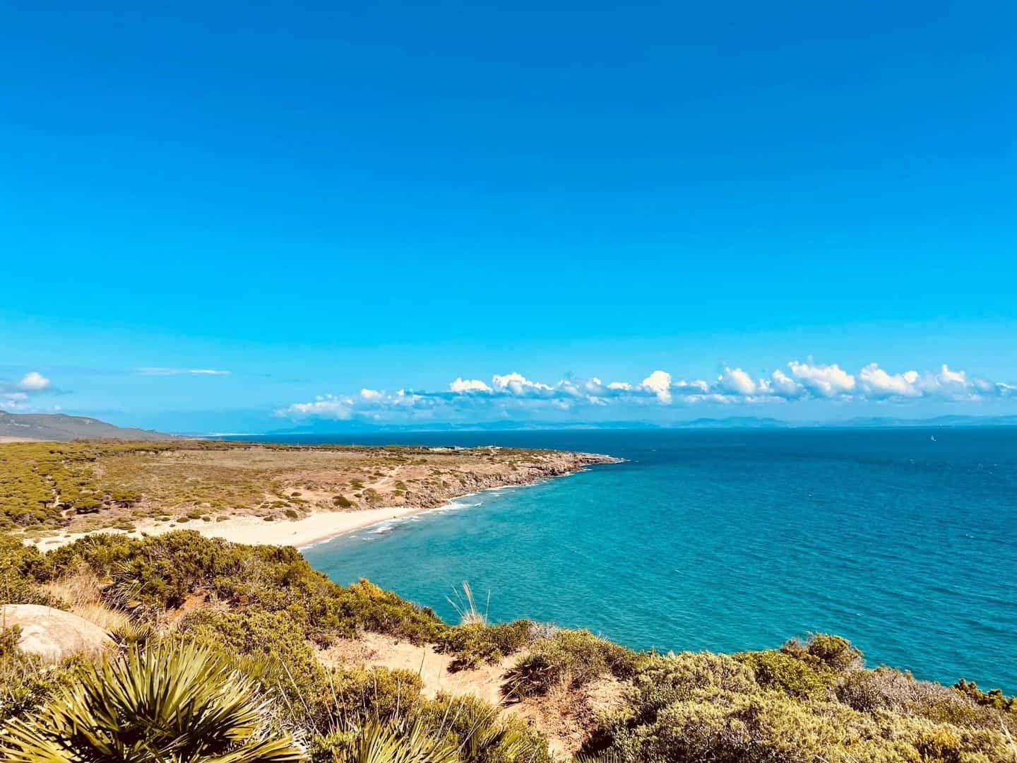 Coastal view of Andalusia with turquoise water, sandy beach and scrubland