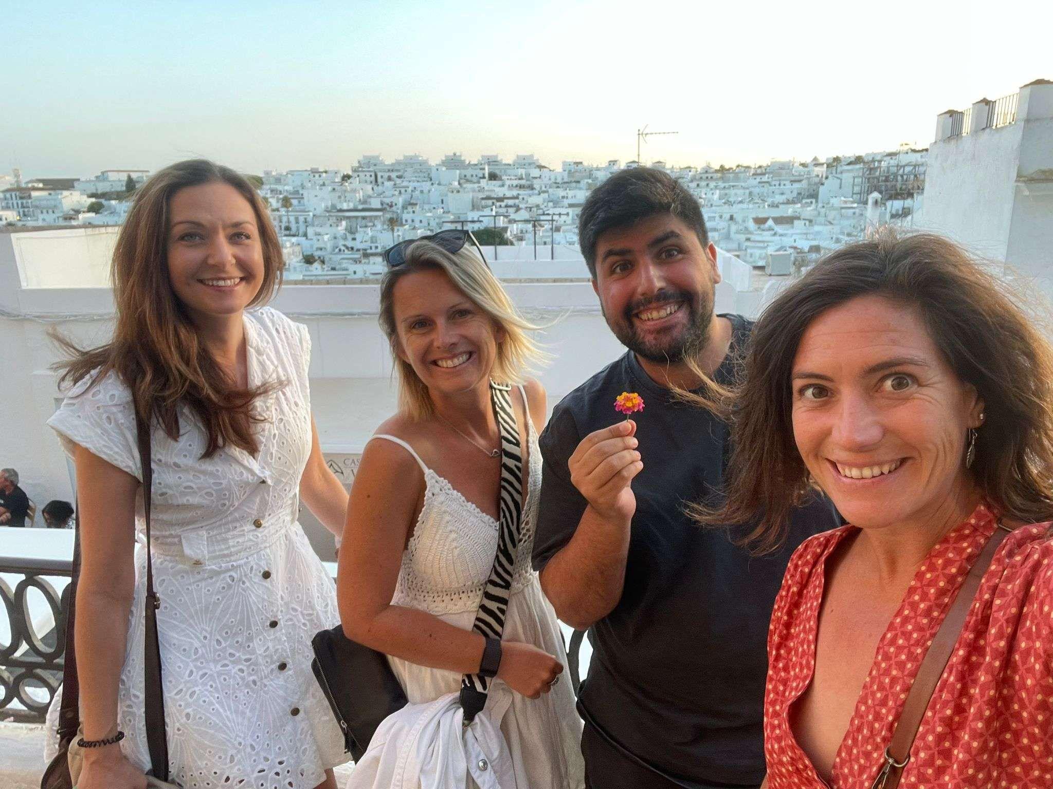4 people with a white village in the background