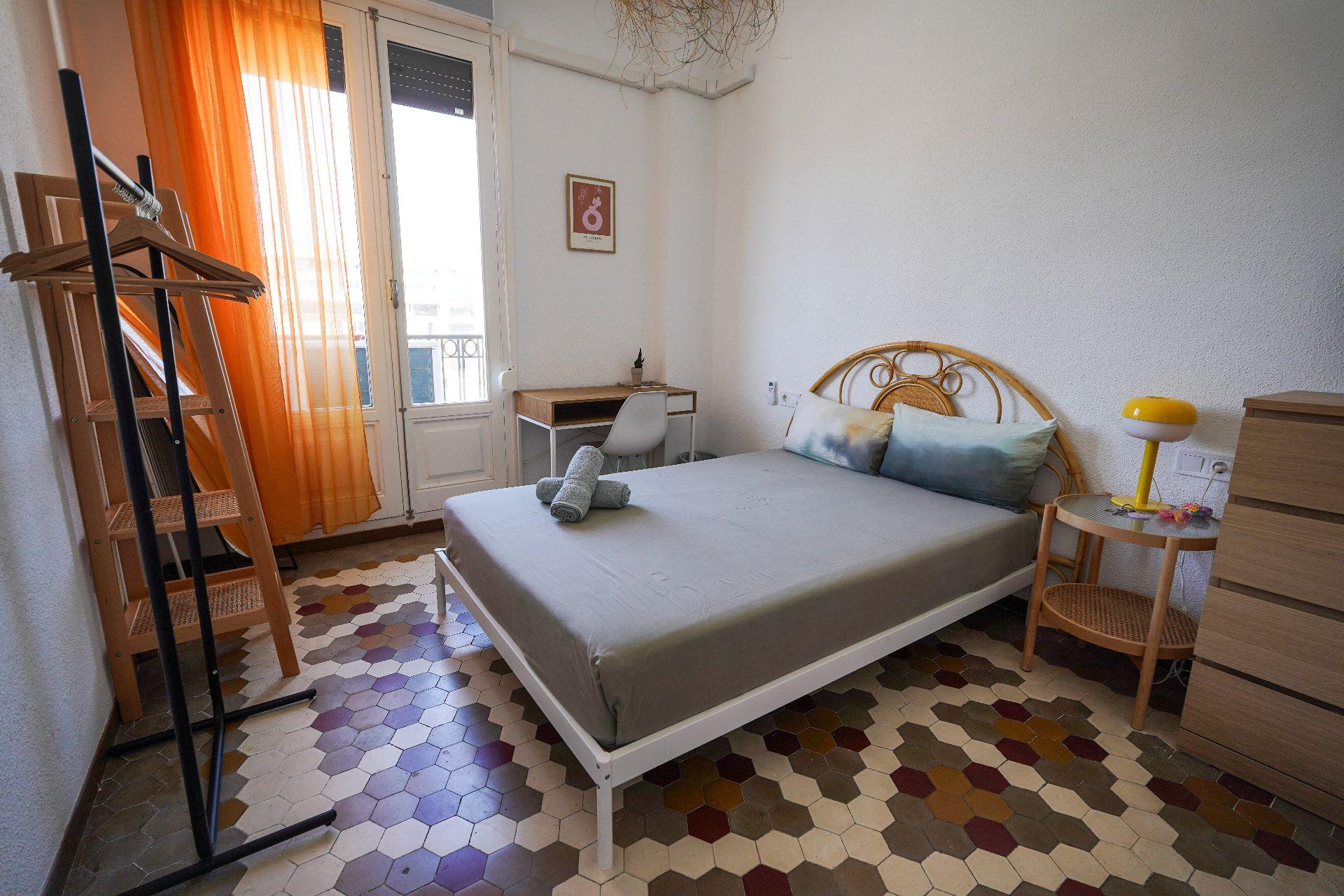 Private room with city view, small balcony, AC, wardrobe, and desk