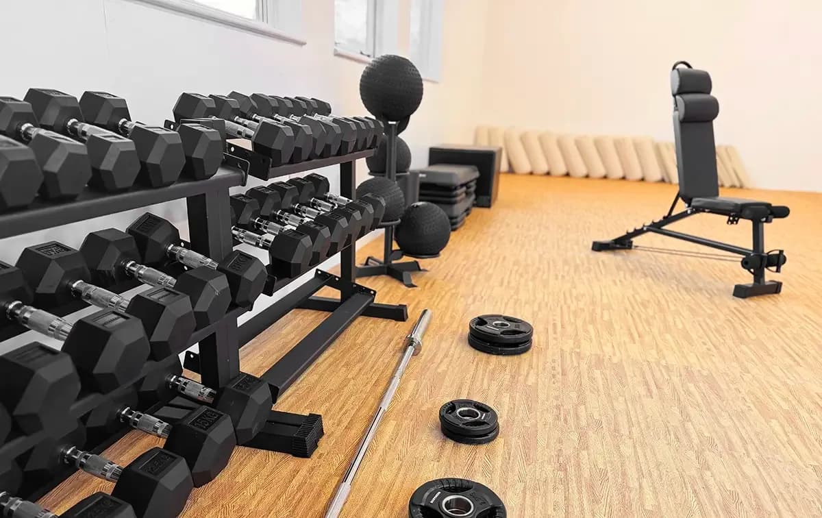Gym with weights and yoga equipment, ready for co-created workouts