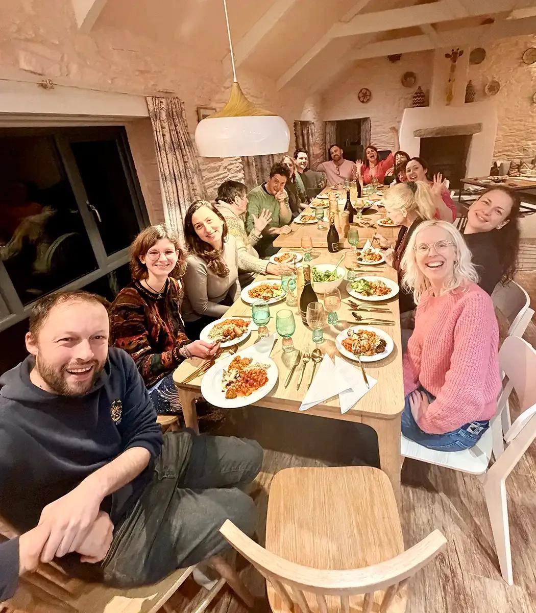 Group of Froomies residents sharing a communal dinner together around a long table