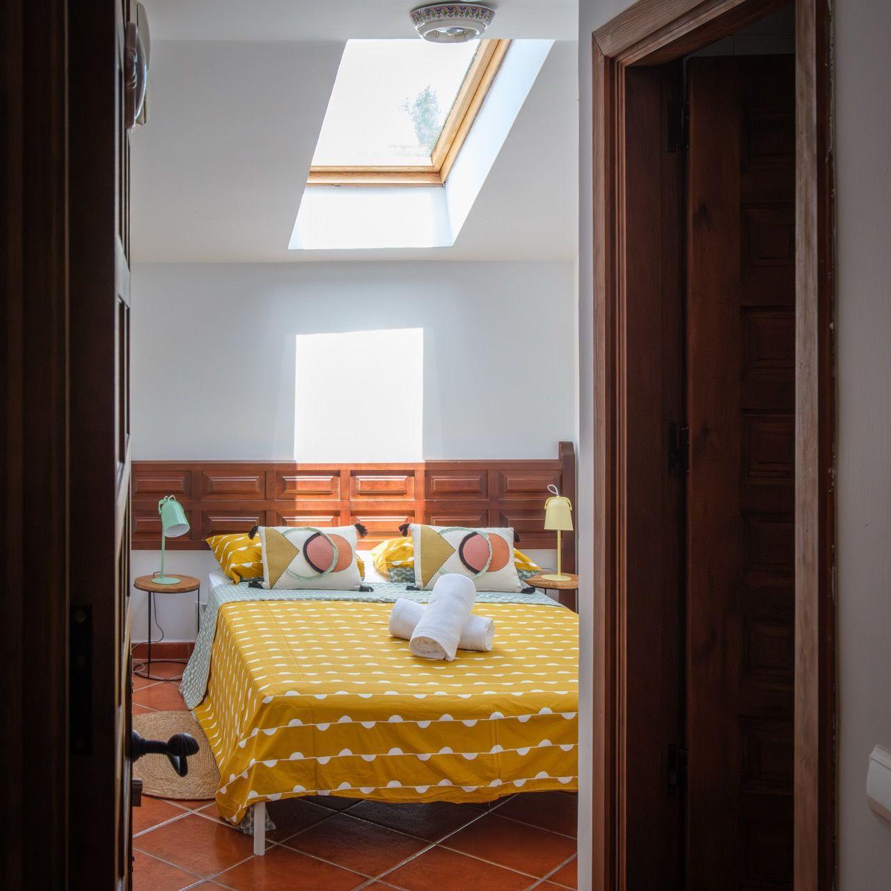 Individually decorated room with yellow skylight