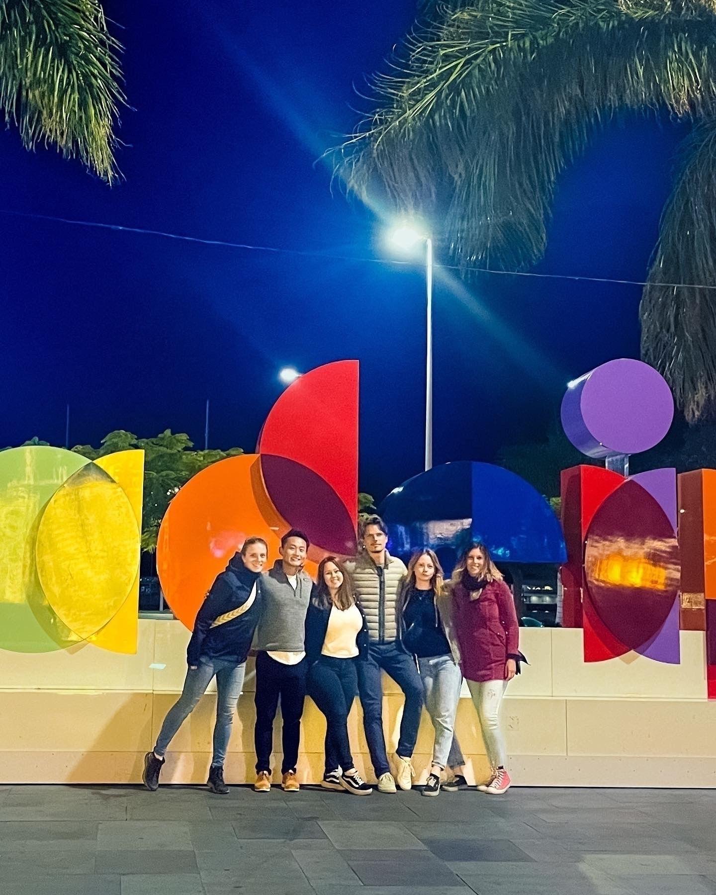Homeoffice Madeira guests come together for a festive Christmas outing in Funchal, posing in front of the new Madeira Island logo to celebrate the holiday season and their unique island experience.