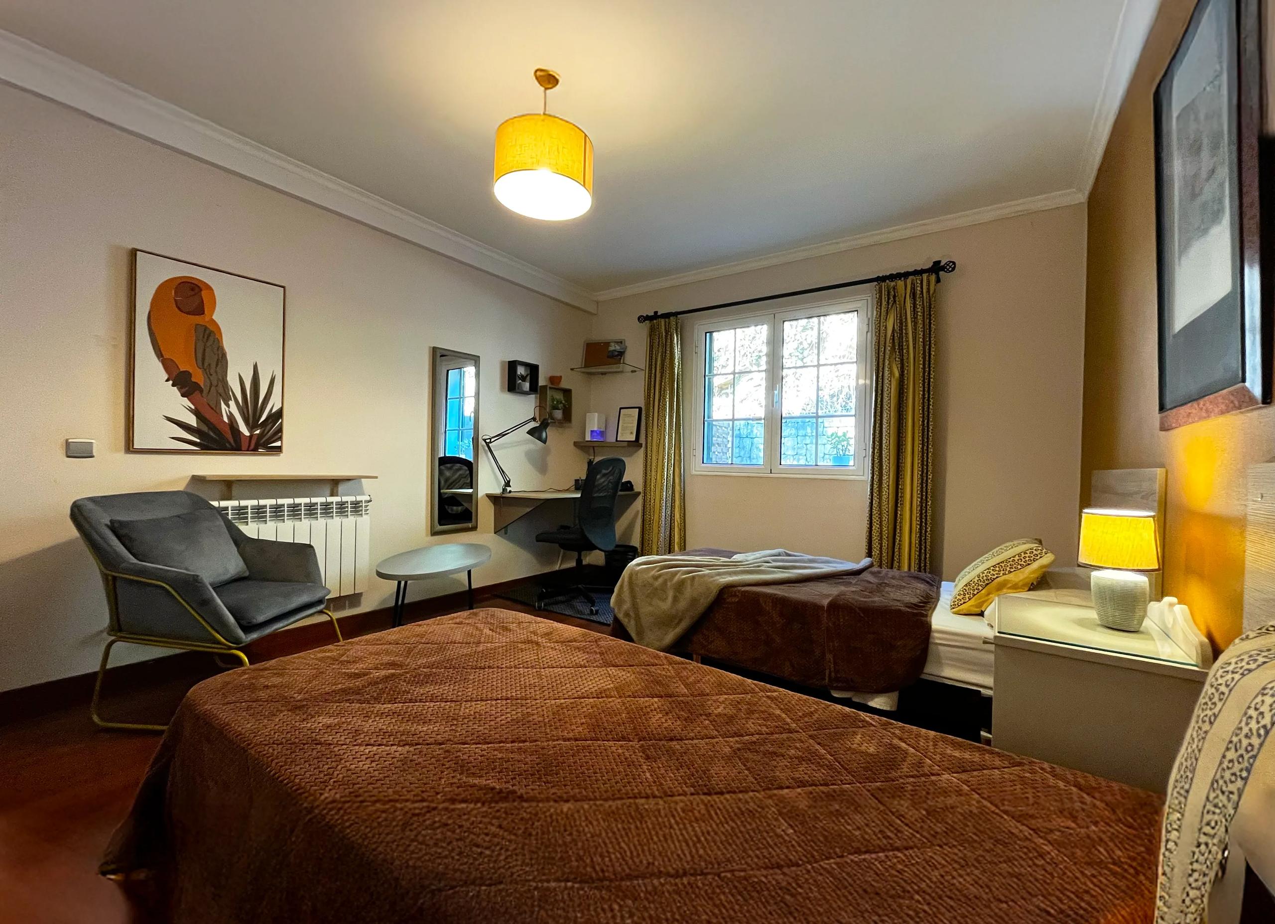 Twin room with two separate beds, desk, and workspace in Room 05 Azálea