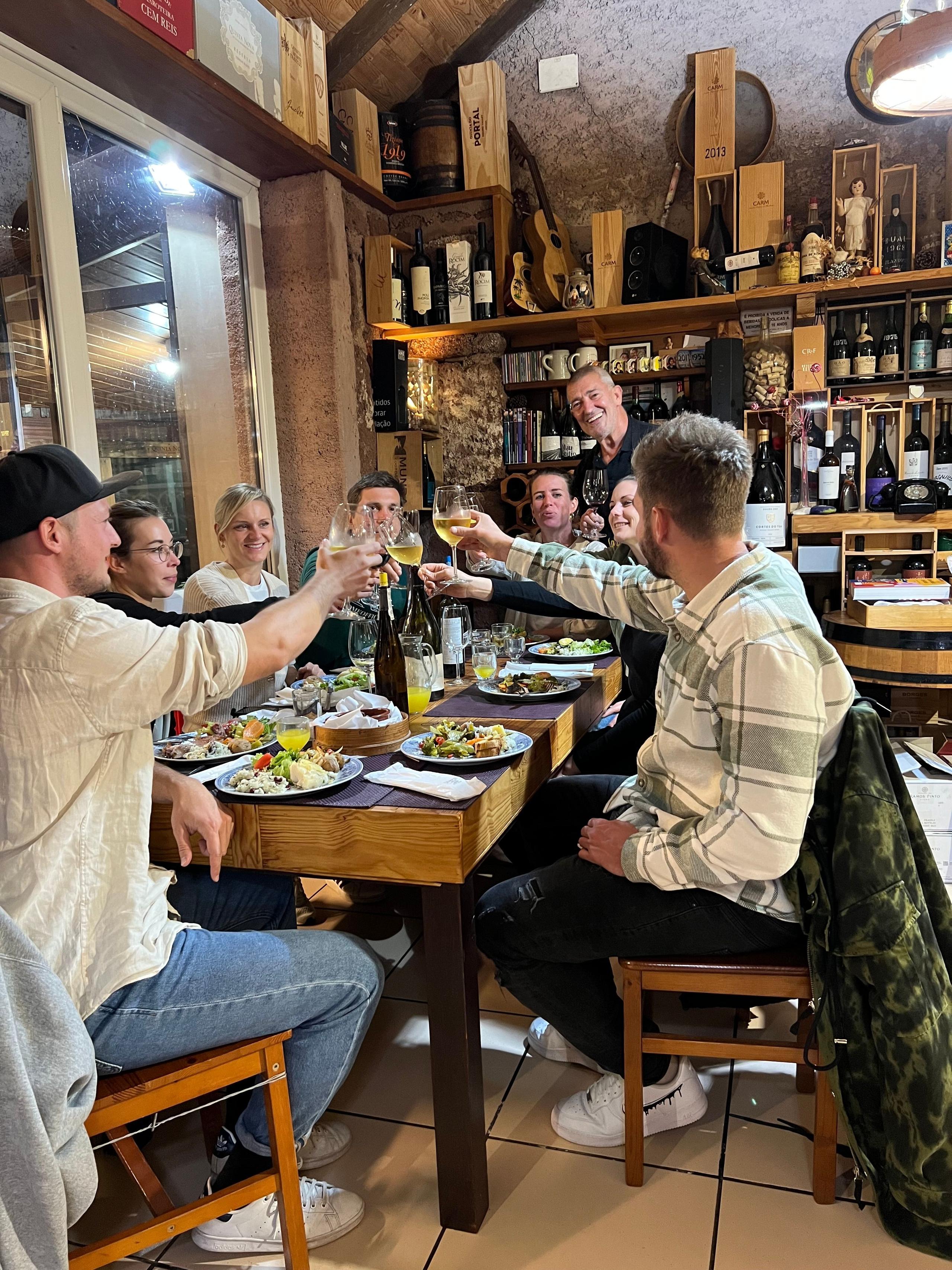 Homeoffice Madeira group toasting at a local restaurant in Madeira, celebrating community and good food