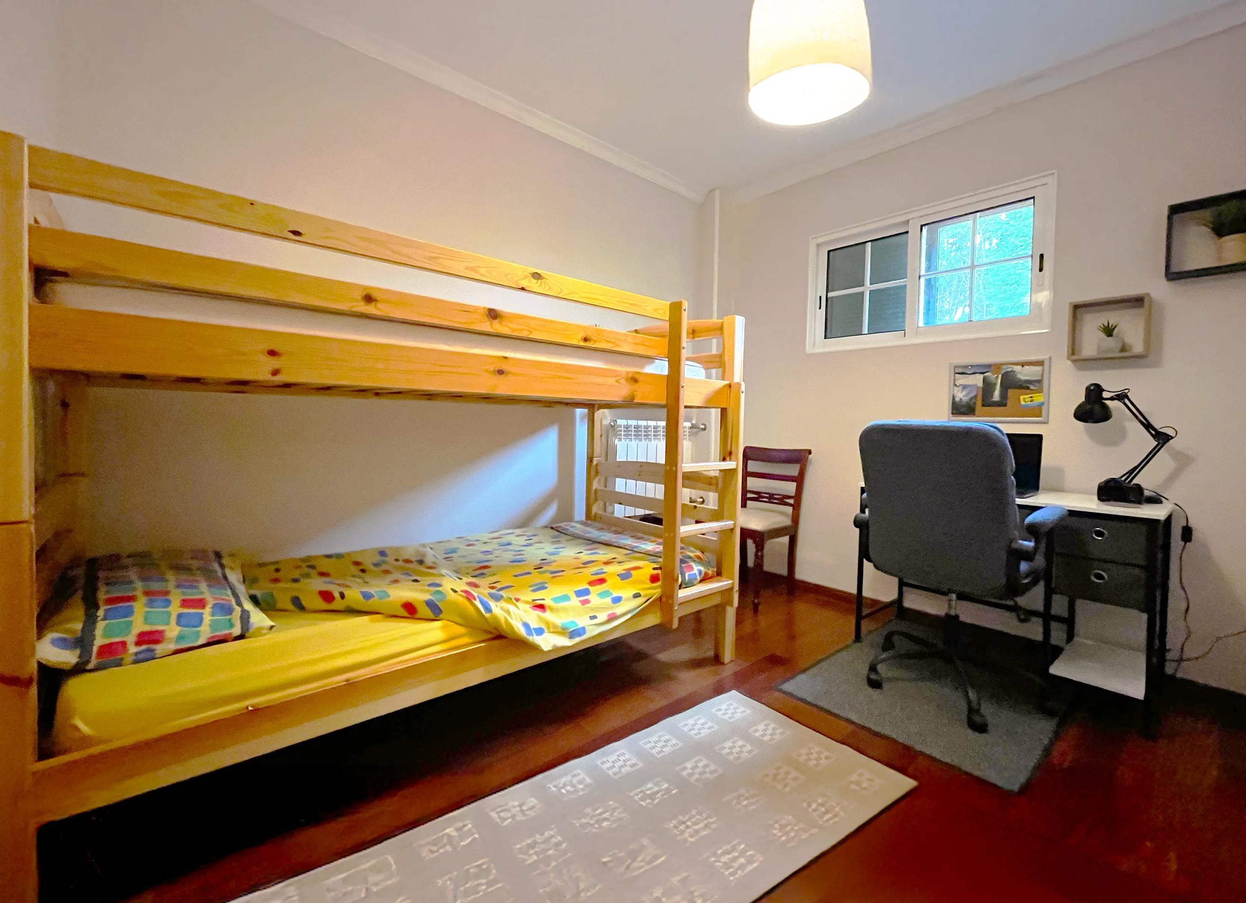 Bunk bed room with wooden bunk beds and desk in Room 06 Camélia
