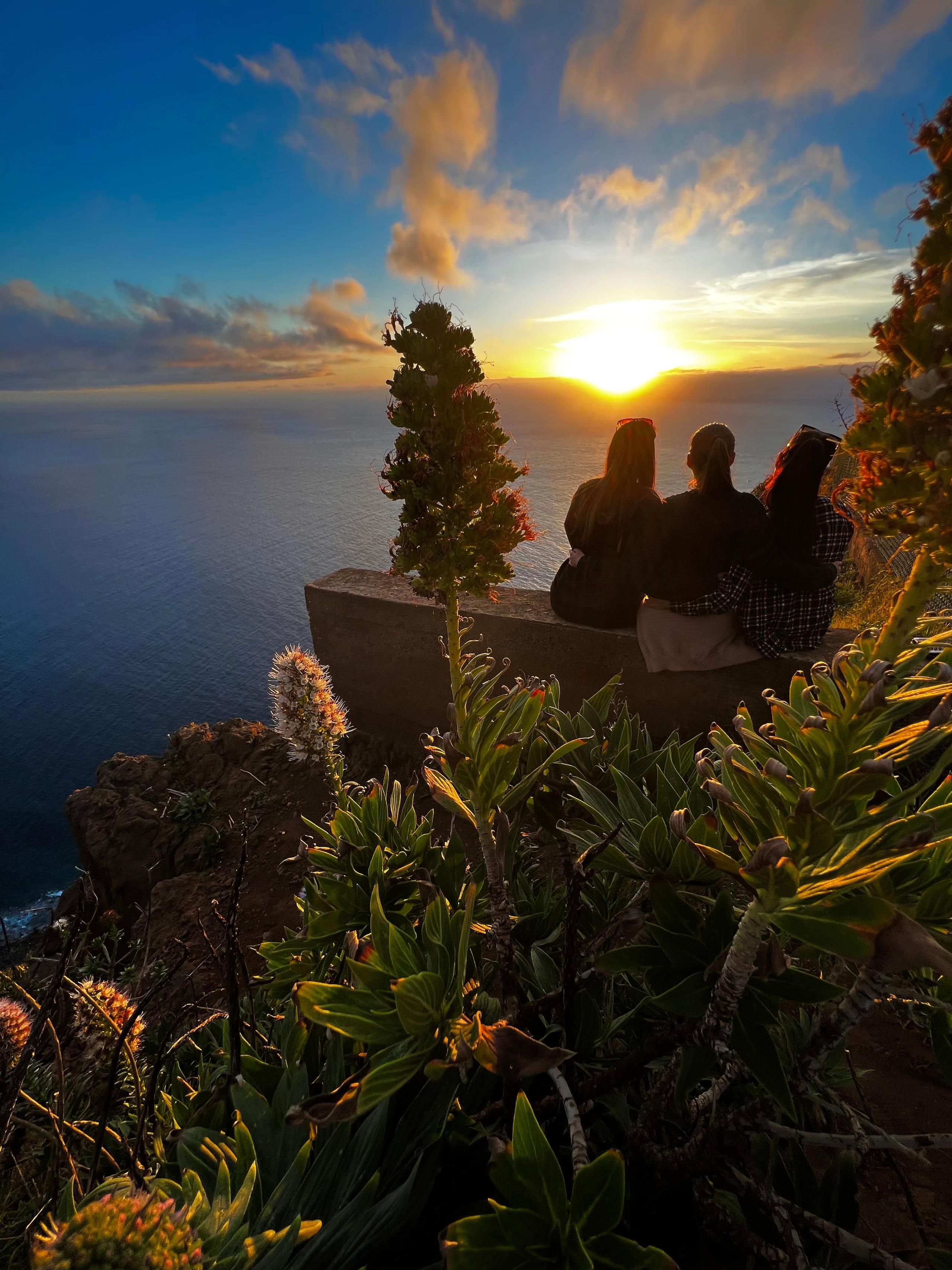 These three ladies are basking in the warm glow of Madeira's unforgettable sunset, creating memories and forging friendships at Homeoffice Madeira.