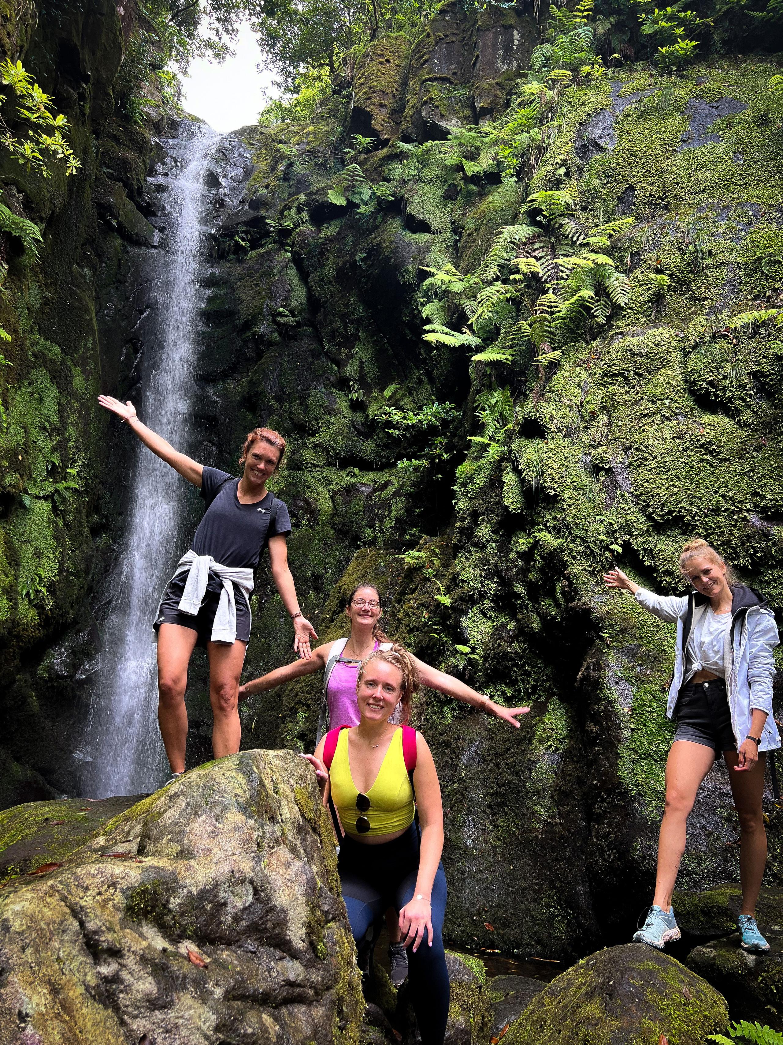 hiker taking a break and enjoying the view on a rocky outcropping on the Poço das Pulgas hike