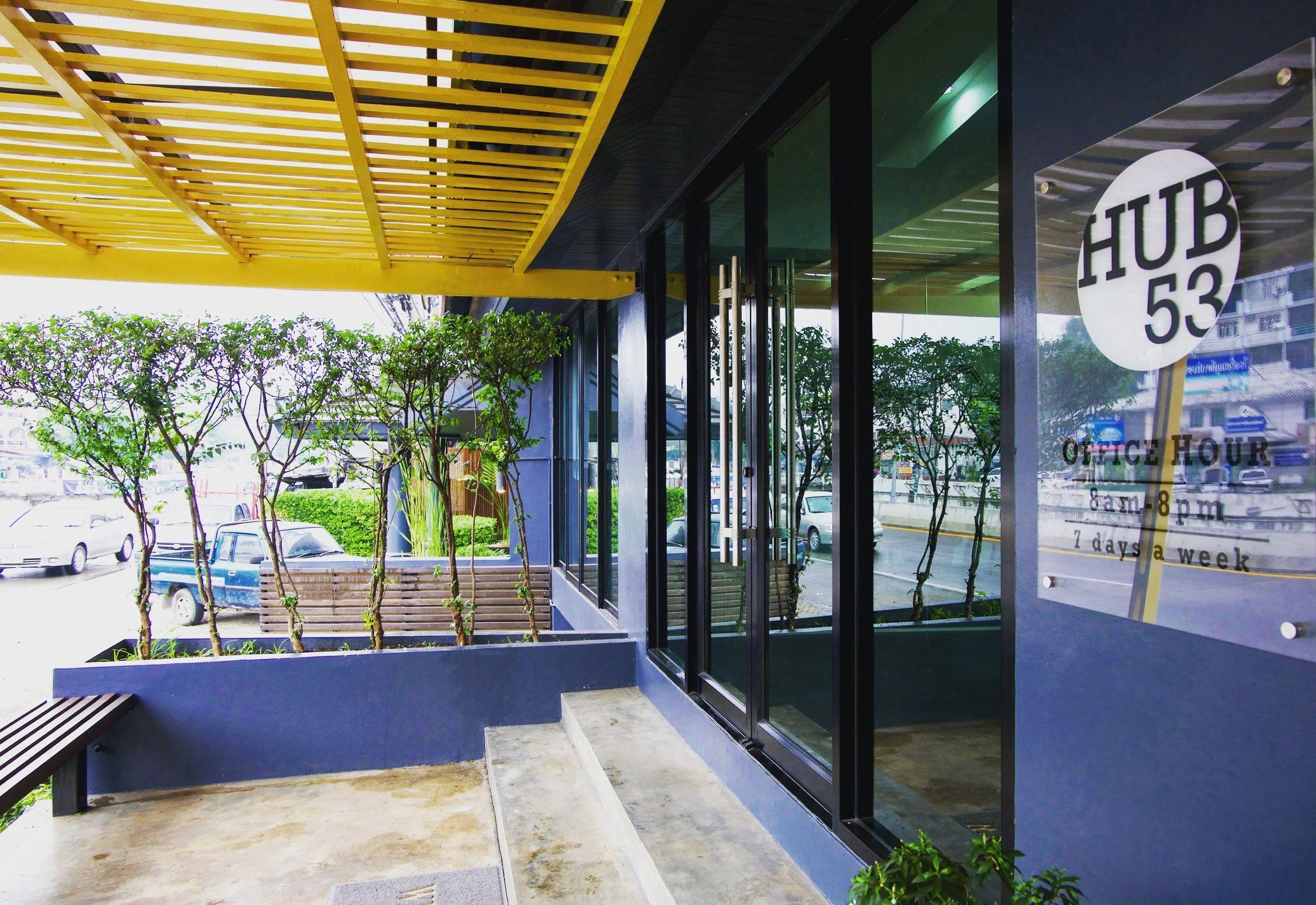 Hub53 building exterior showing the entrance with Hub 53 signage, yellow canopy, glass facade and street-level view