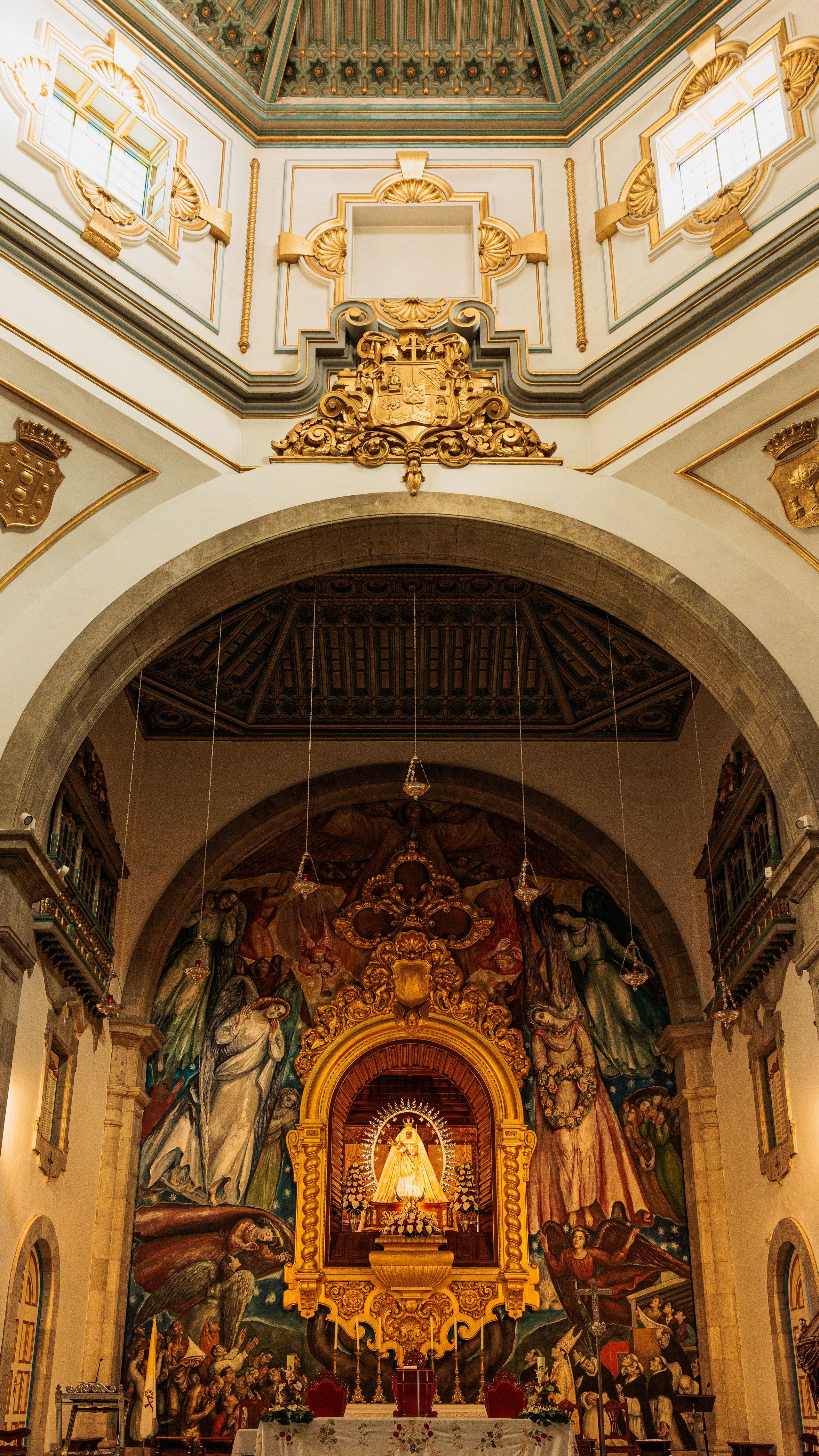Interior of a historic church in Tenerife with ornate golden altar