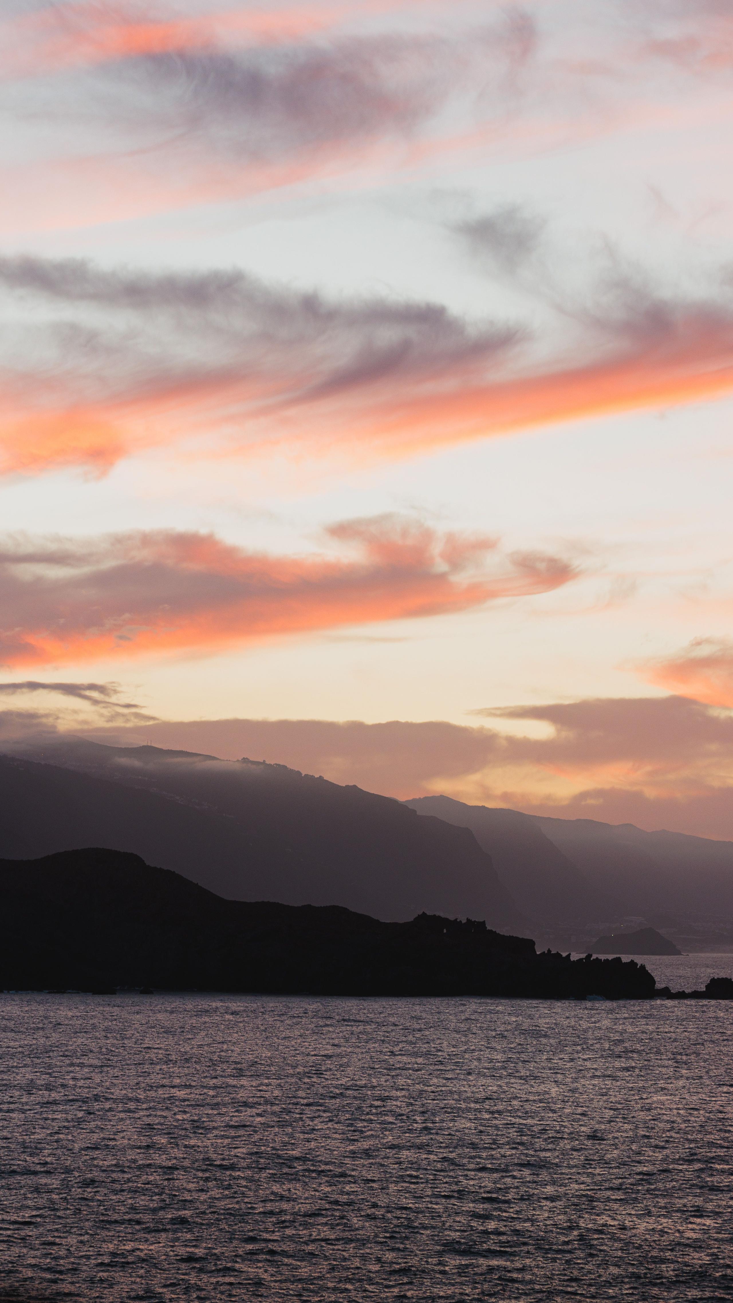Peaceful ocean sunset with mountain silhouettes in Tenerife