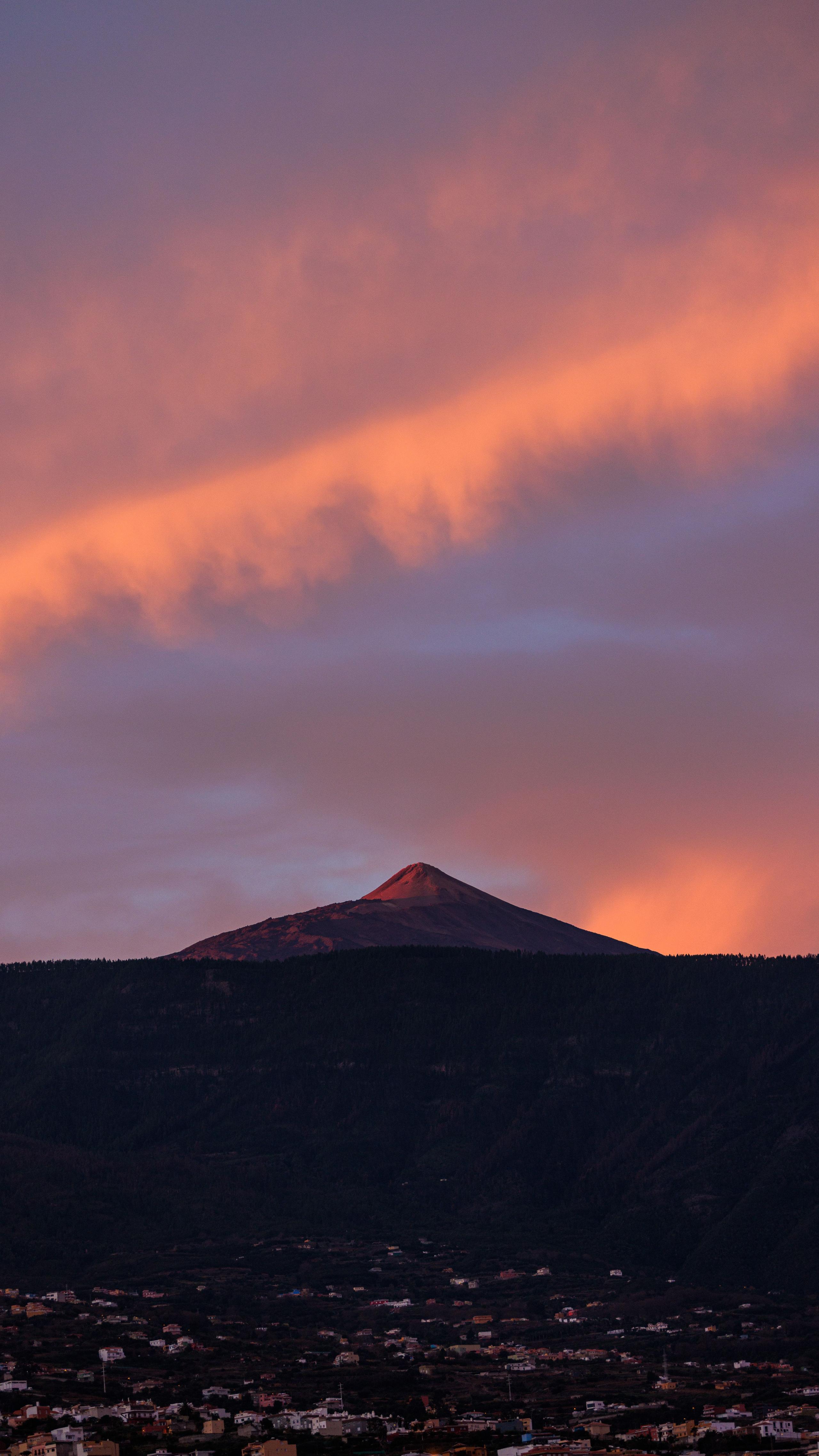 Teide volcano silhouetted against a dramatic pink and orange sunset sky