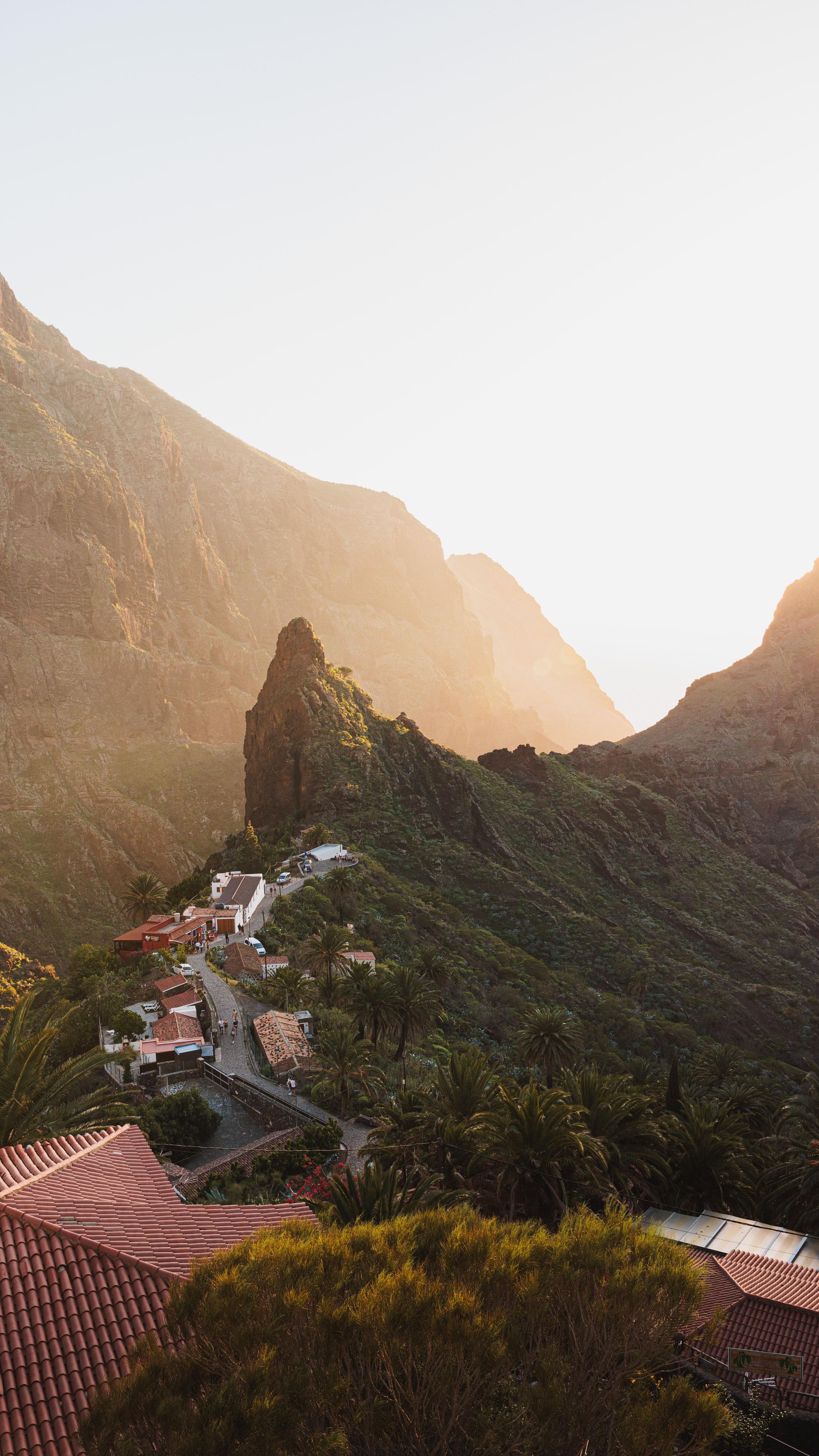 Scenic view of Masca village nestled in a dramatic mountain gorge at sunset