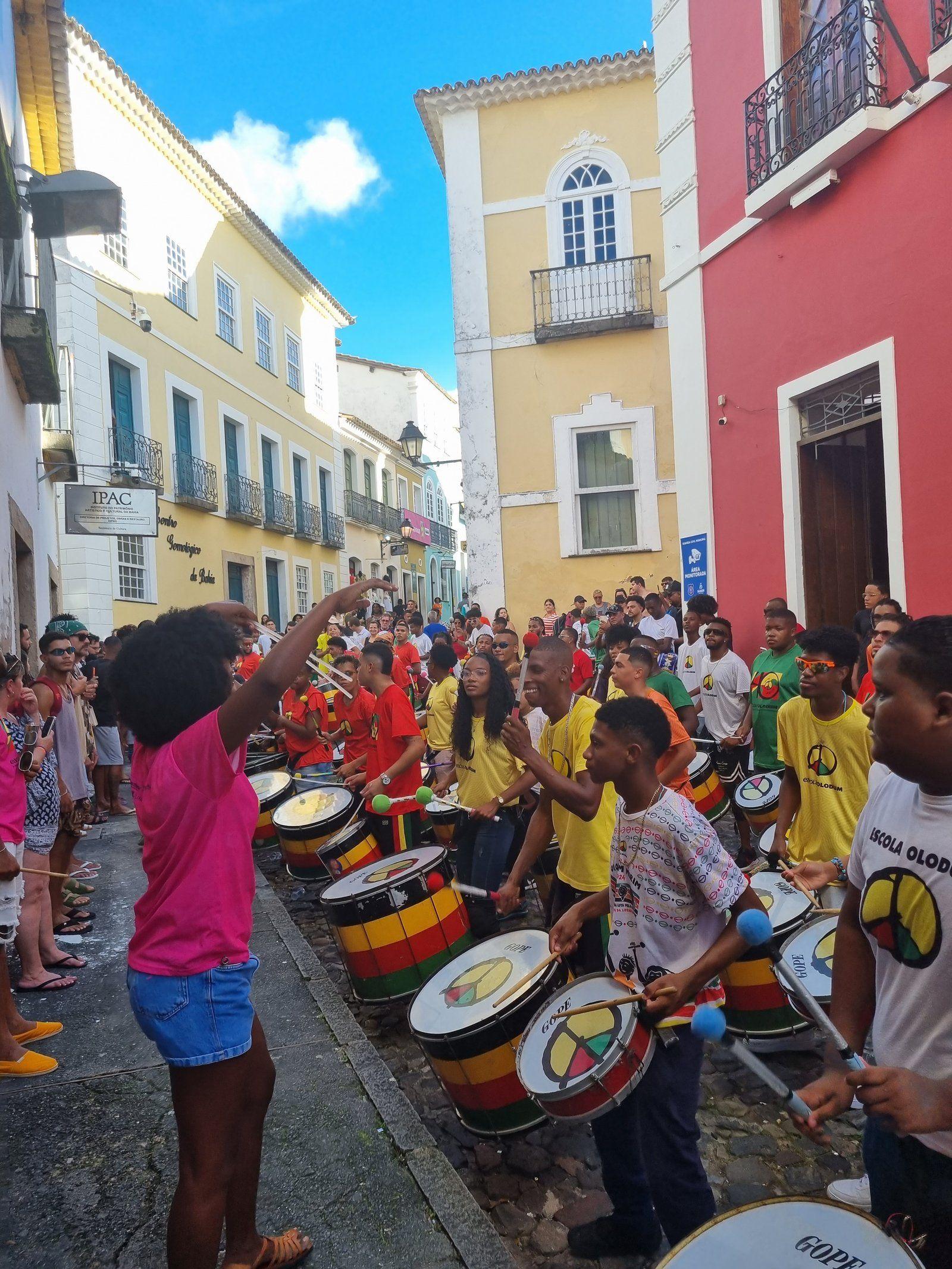 A lively street parade in Salvador's historic Pelourinho district with Olodum school drummers in colorful uniforms.