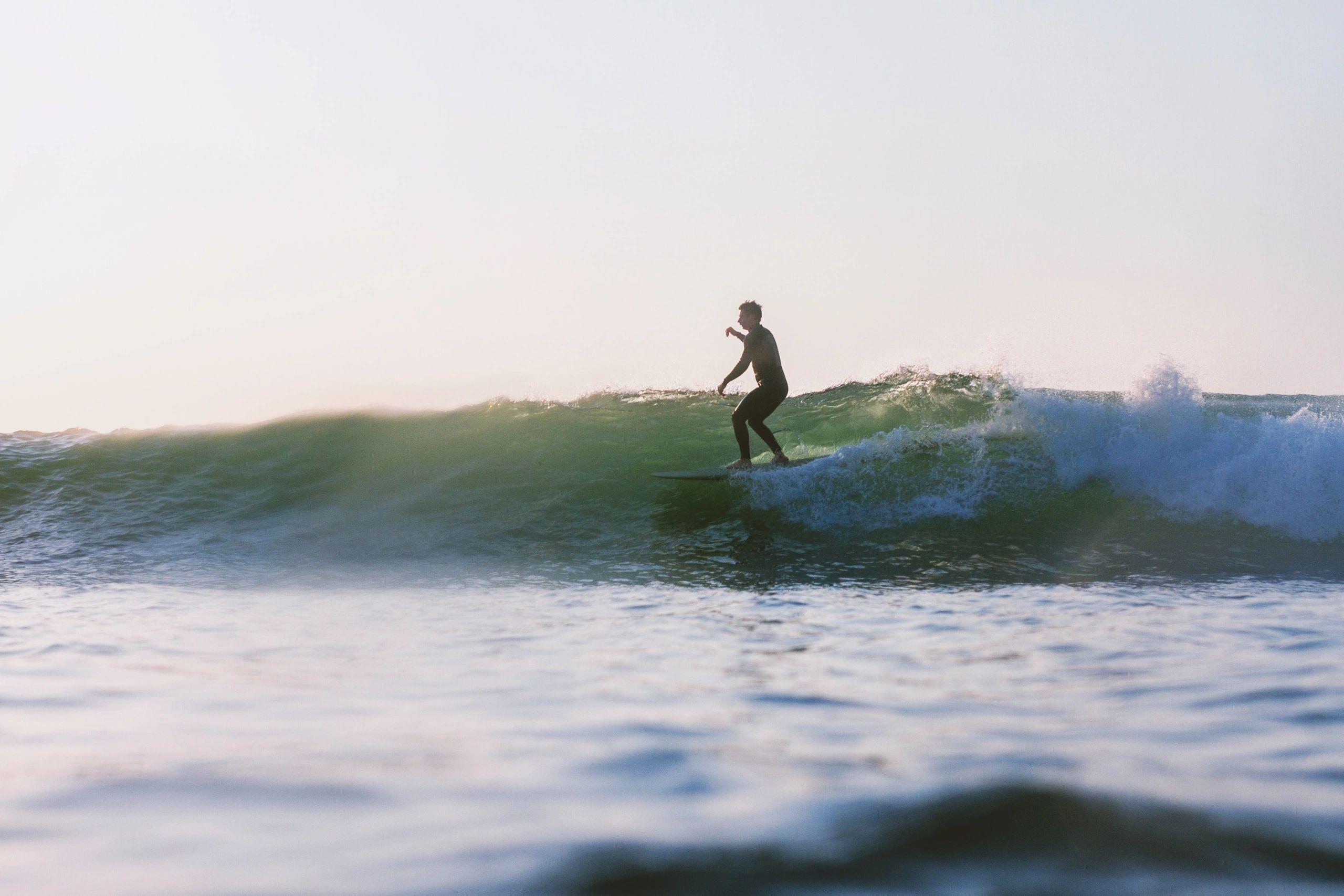 Silhouette of a surfer riding a wave at JBay