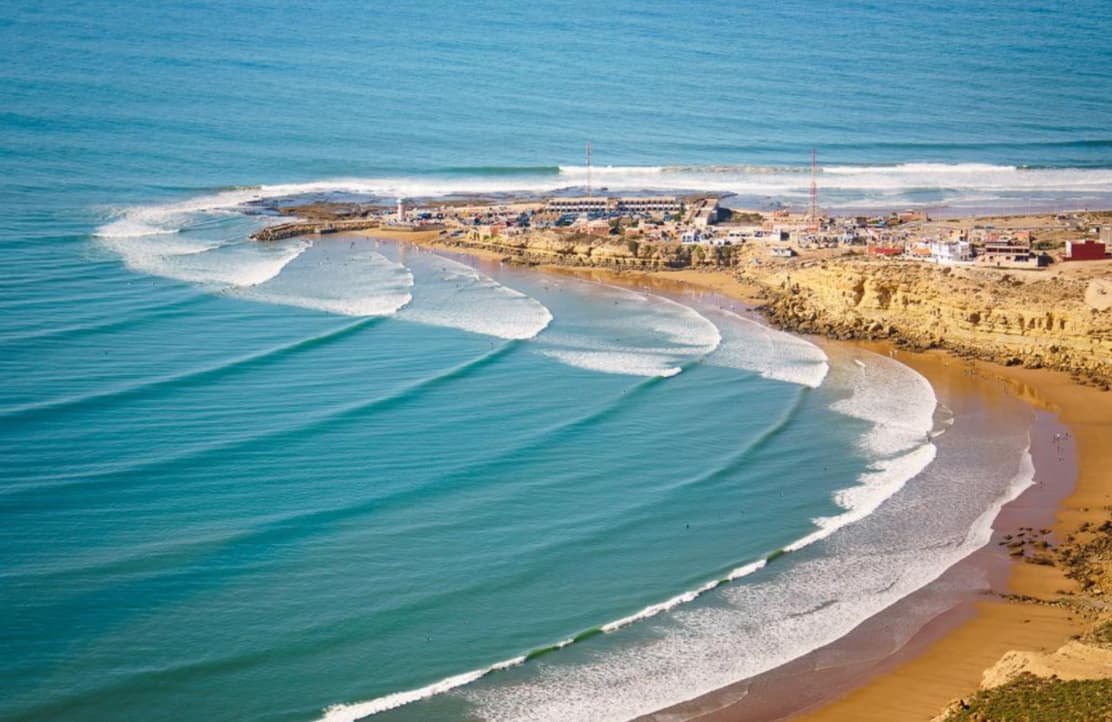 Aerial view of the beach and coastline near Tamraght, Morocco with waves rolling in