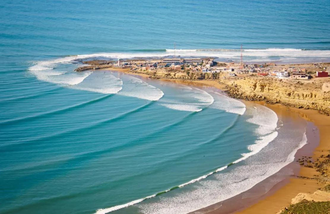 Aerial view of the beach and coastline near Tamraght, Morocco with waves rolling in